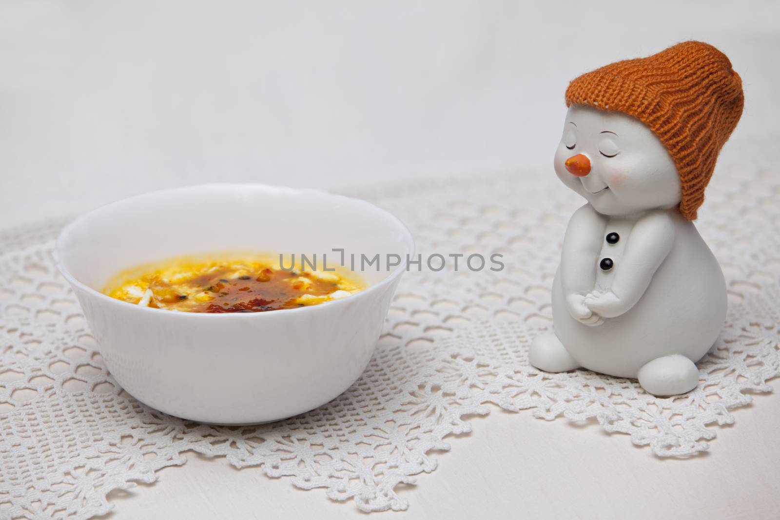 Ice cream cup with jam and a snowman figurine by mrivserg
