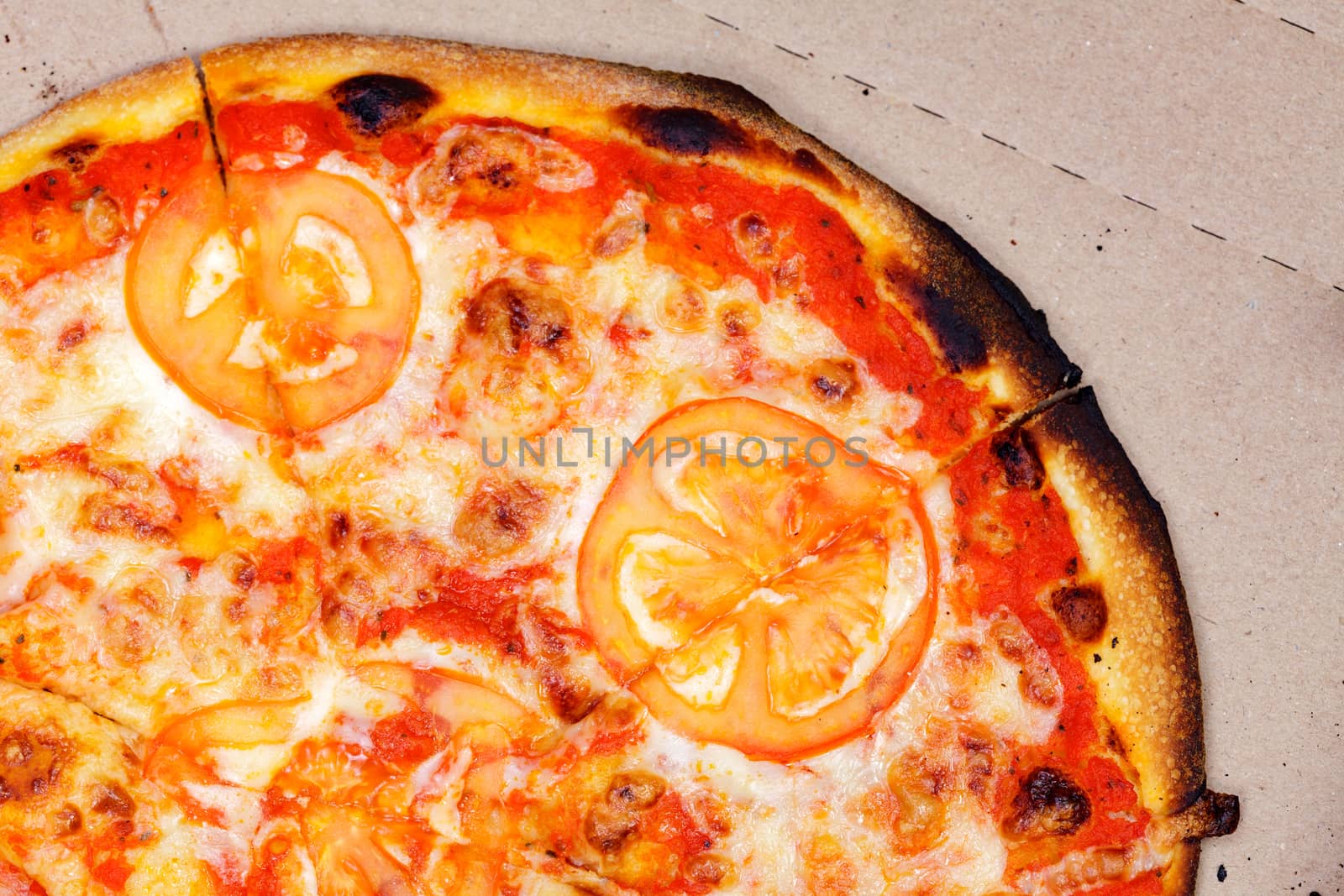 Closeup shot of burnt pizza in a carton box