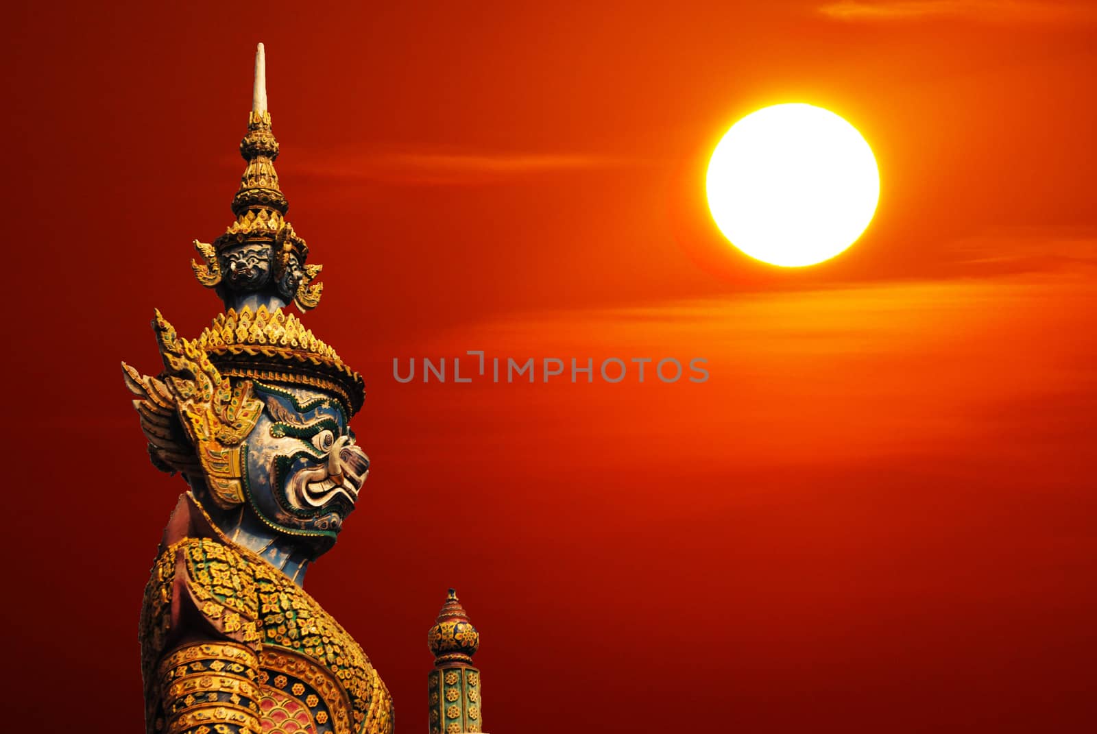 Statue of demon guardian statue in Thailand with Sun and copyspa by hongee