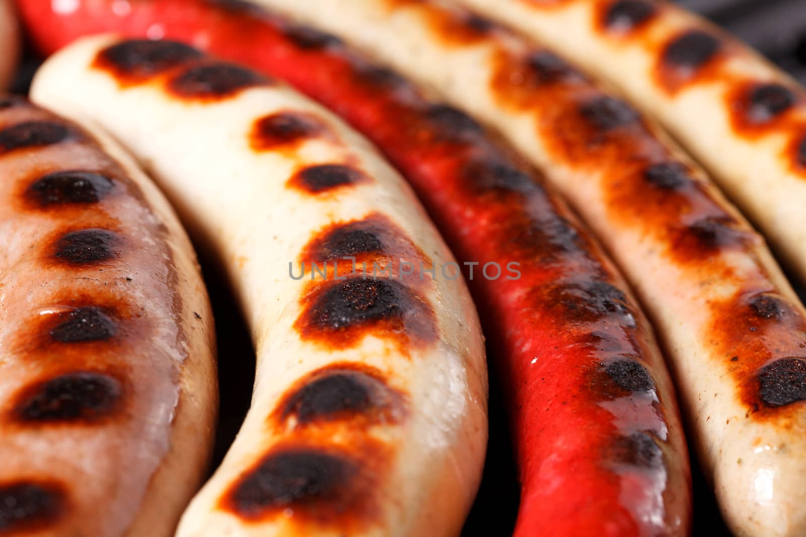 Closeup shot of sausages on a grill by Nobilior
