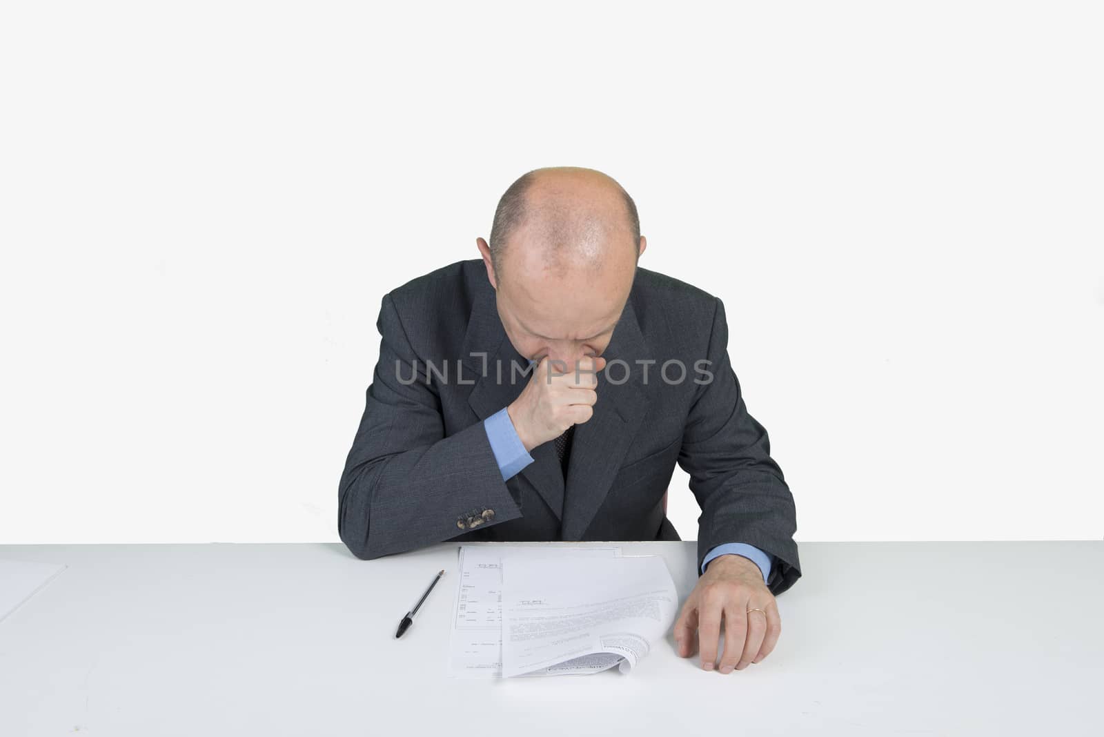 a worried man reads a document