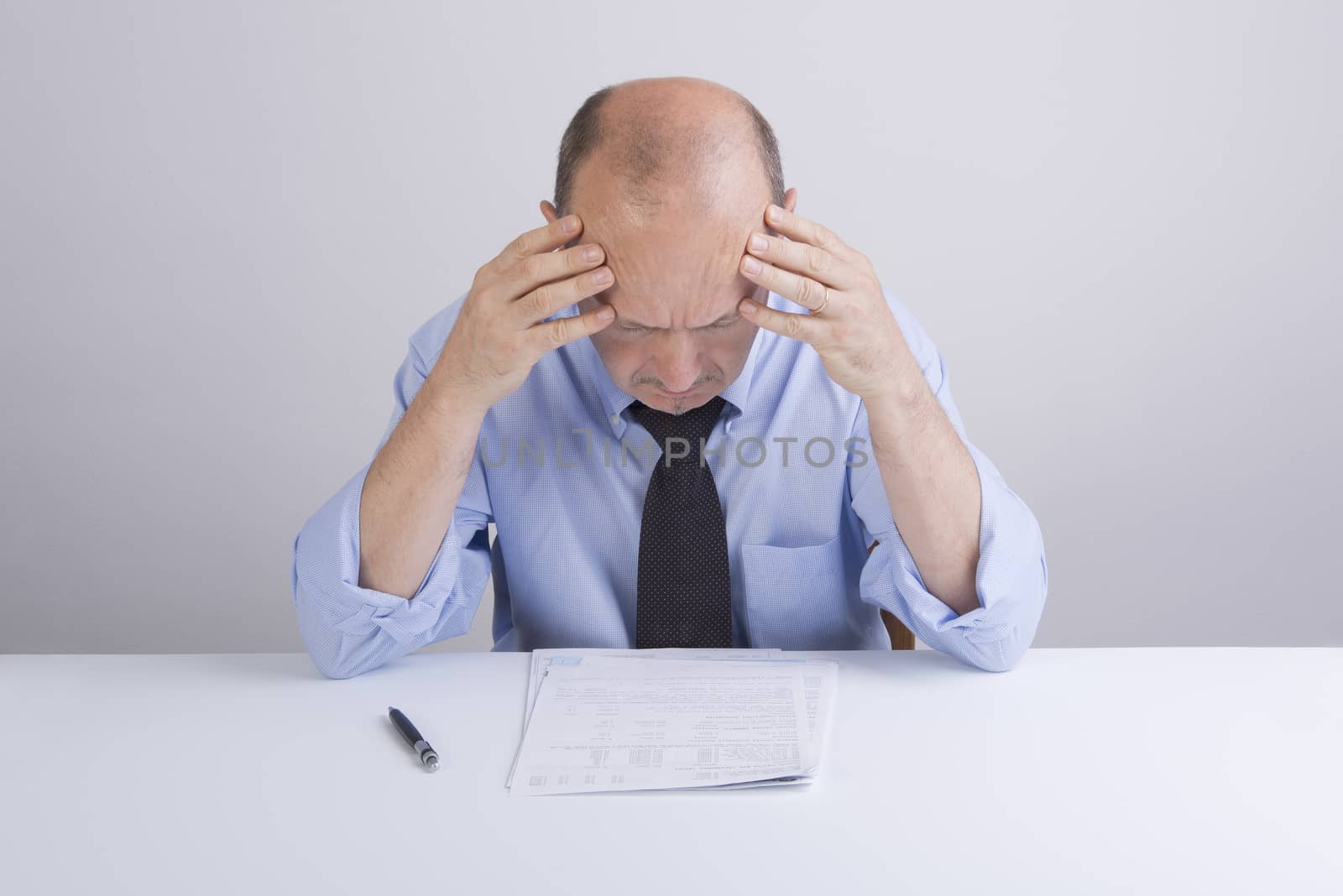 a worried man reading a document