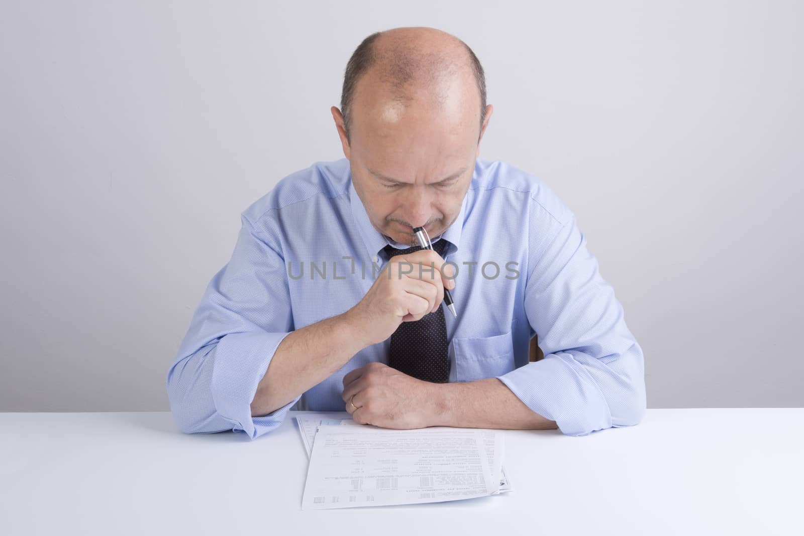 a worried man reading a document