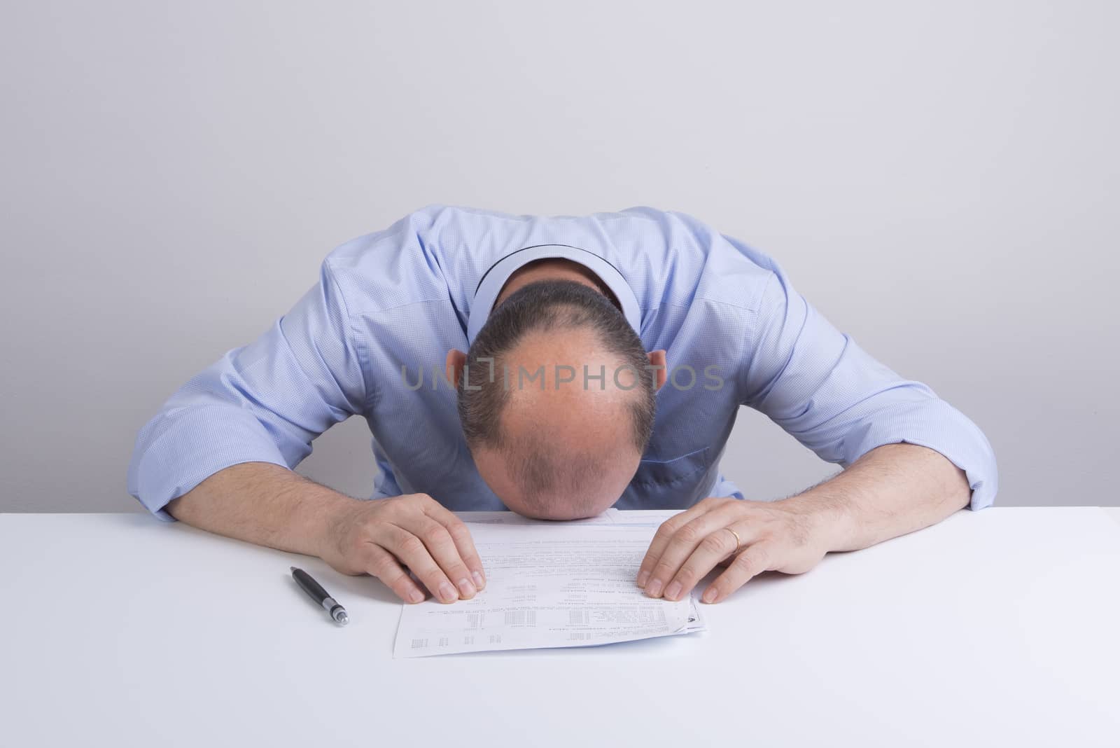 a worried man in front a document