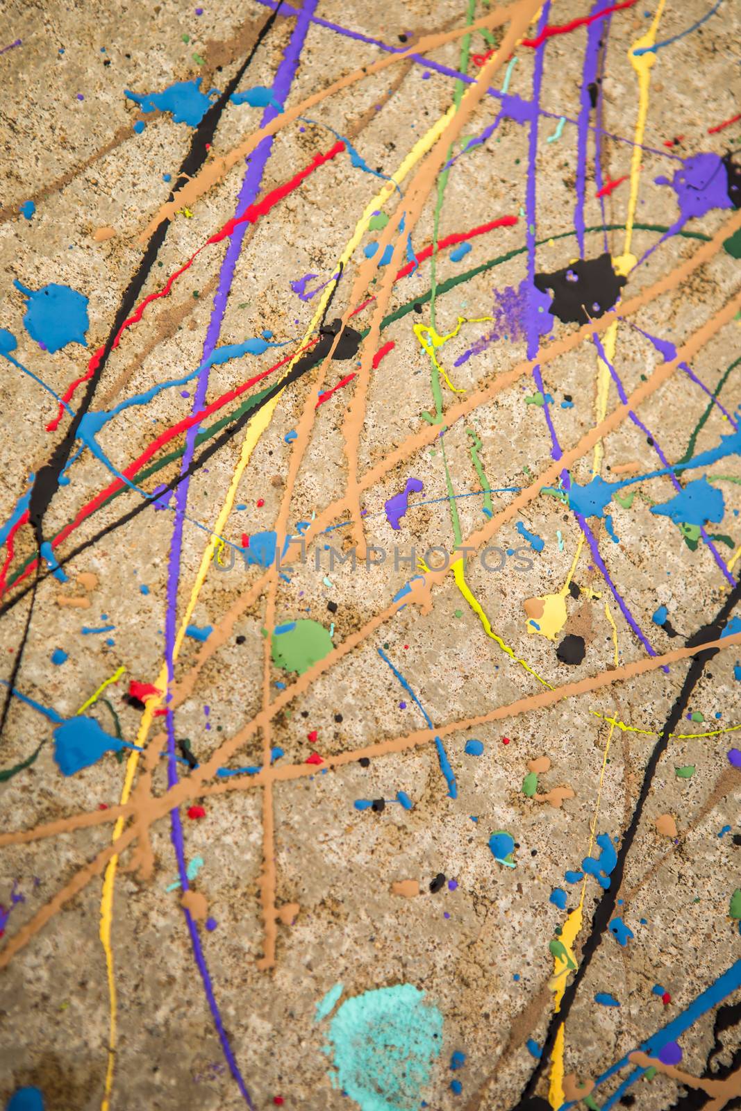 Colorful paint swirl on concrete background. by salejandro