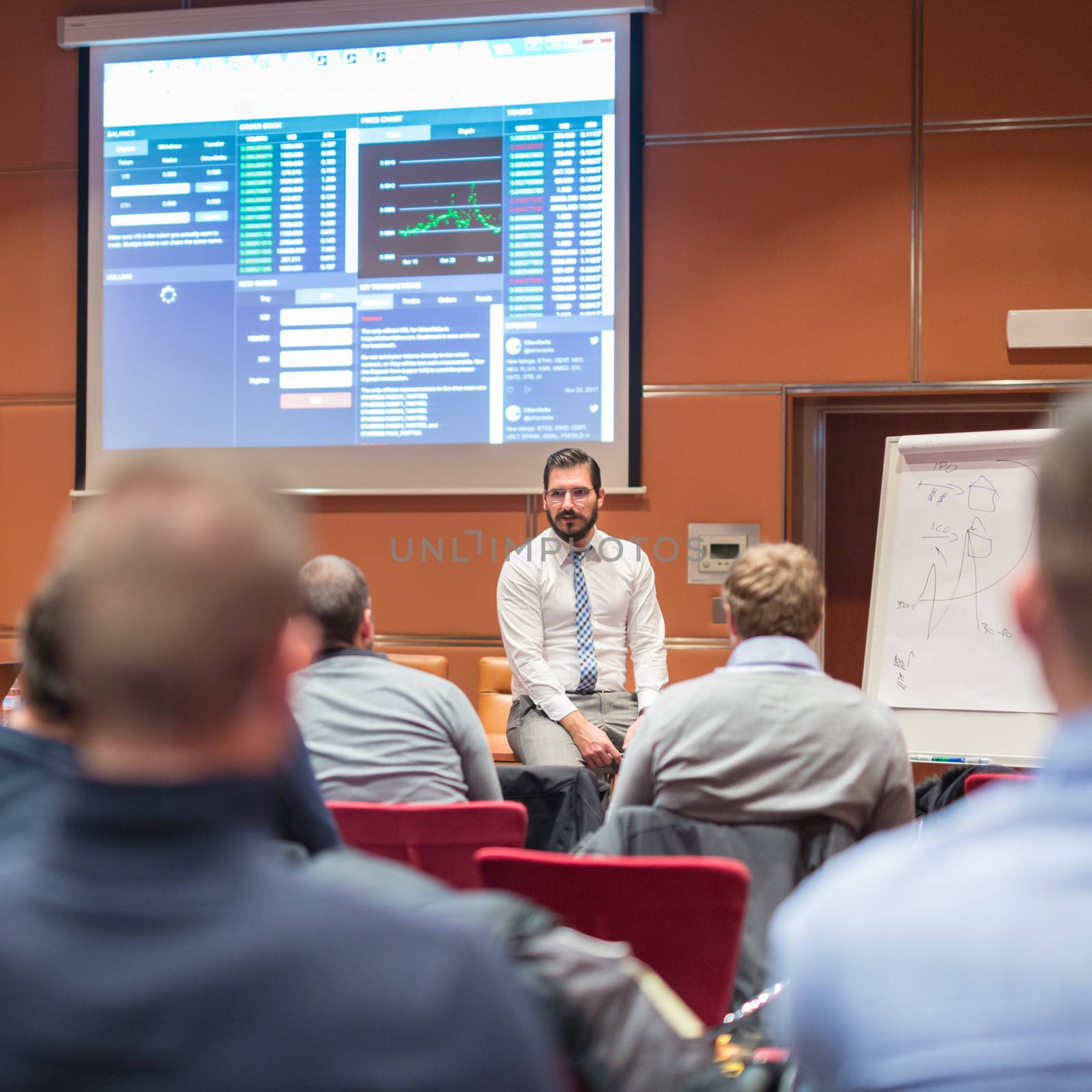 Relaxed Businessman Giving a Talk at Informal Business Meeting. Audience in the conference hall. Business and Entrepreneurship concept.