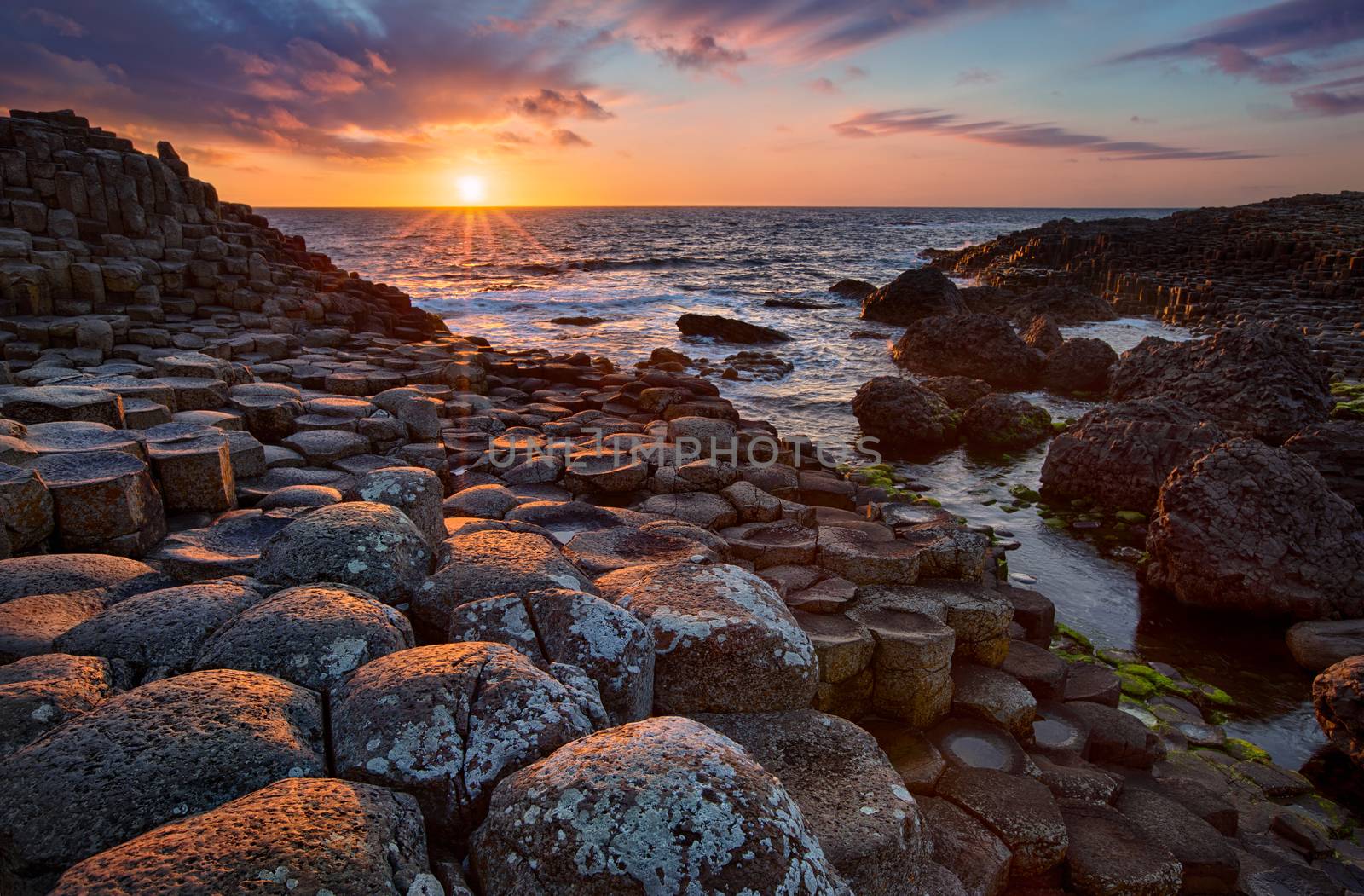 sunset over basalt columns Giant's Causeway known as UNESCO World Heritage Site, County Antrim, Northern Ireland