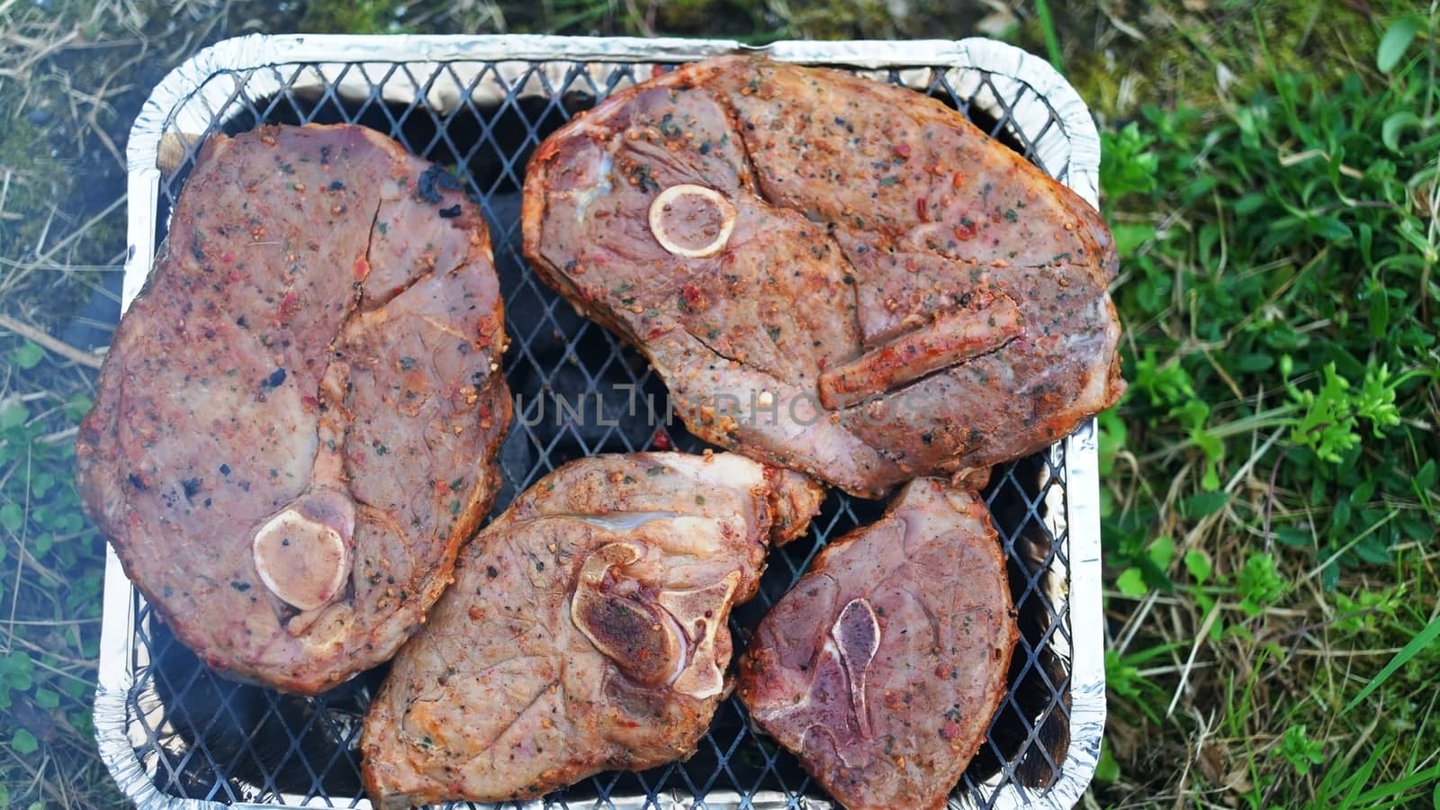 Lamb steaks cooking on disposable grill, Iceland