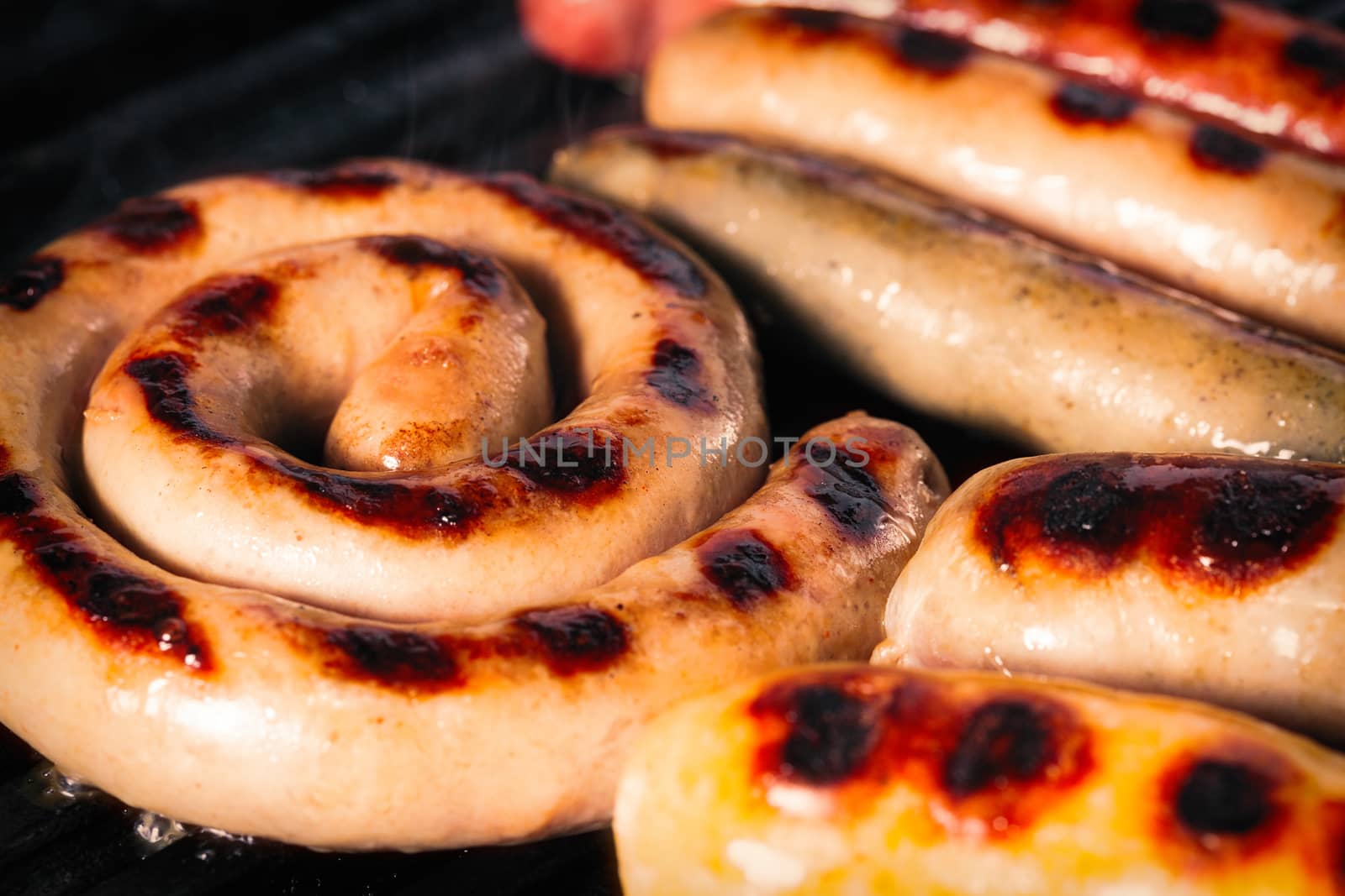 Closeup shot of sausages on a grill by Nobilior