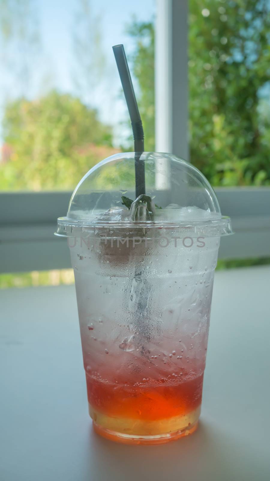 Red soda in glass put on table