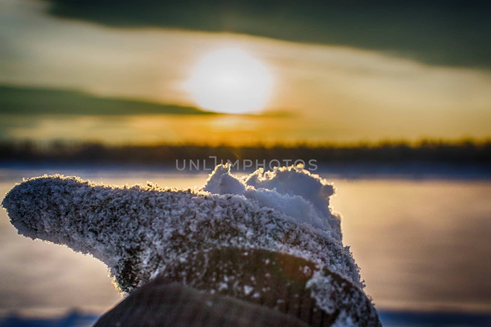 Hands with a beautiful sky winter sunset on the river