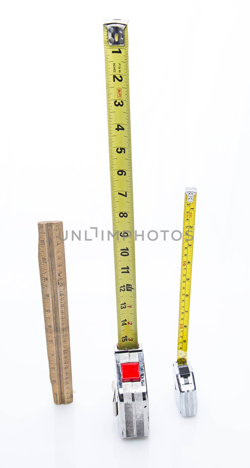 wood rulers and two different mesuring tape place vertically