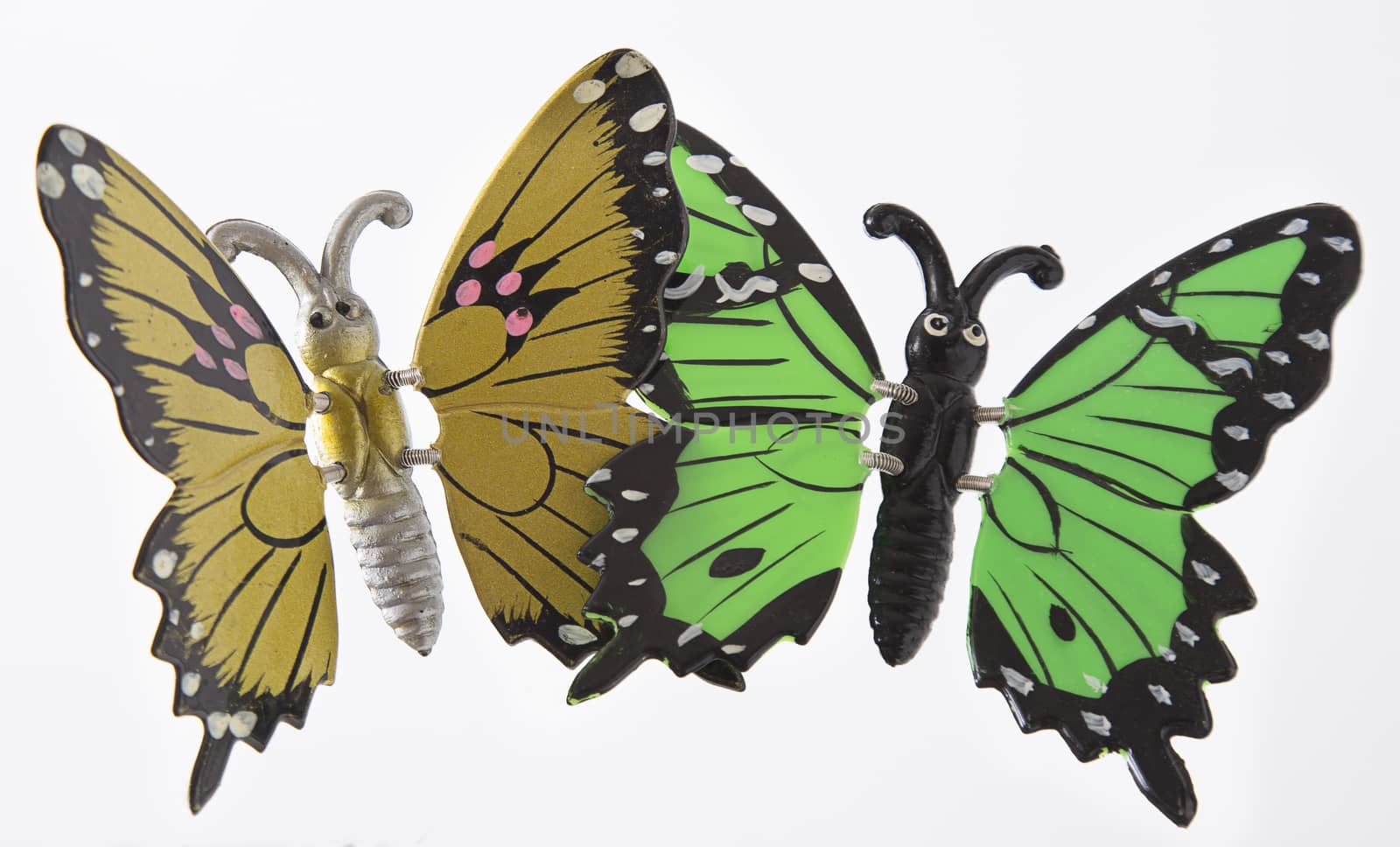 yellow and green metal toy butterfly