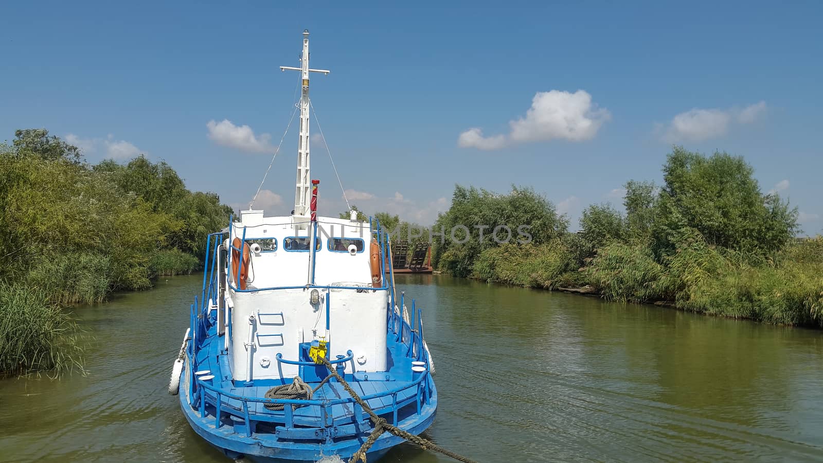 Tug boat on a small delta navigation channel by shoricelu