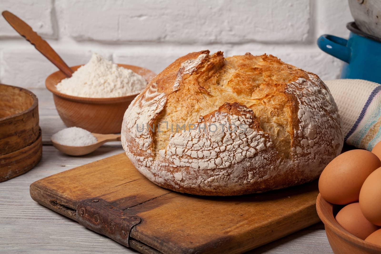 Homemade bread on old cutting board by igor_stramyk