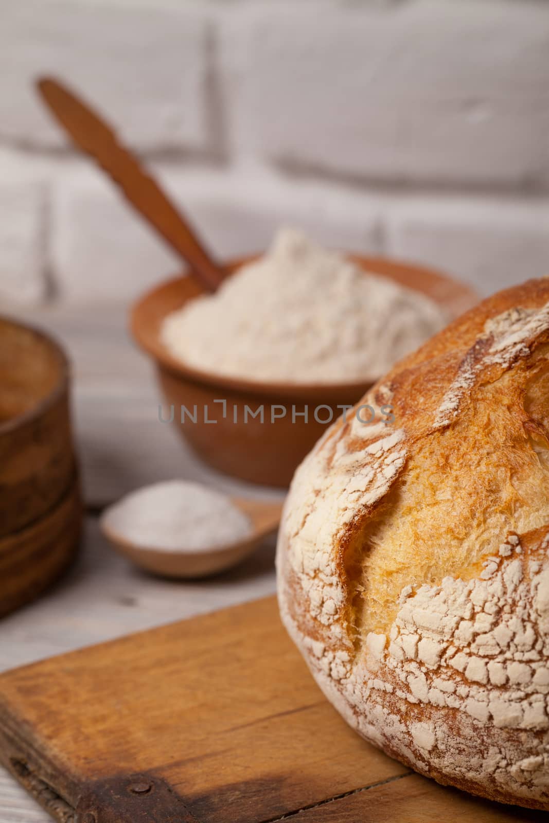 Homemade bread on old cutting board by igor_stramyk