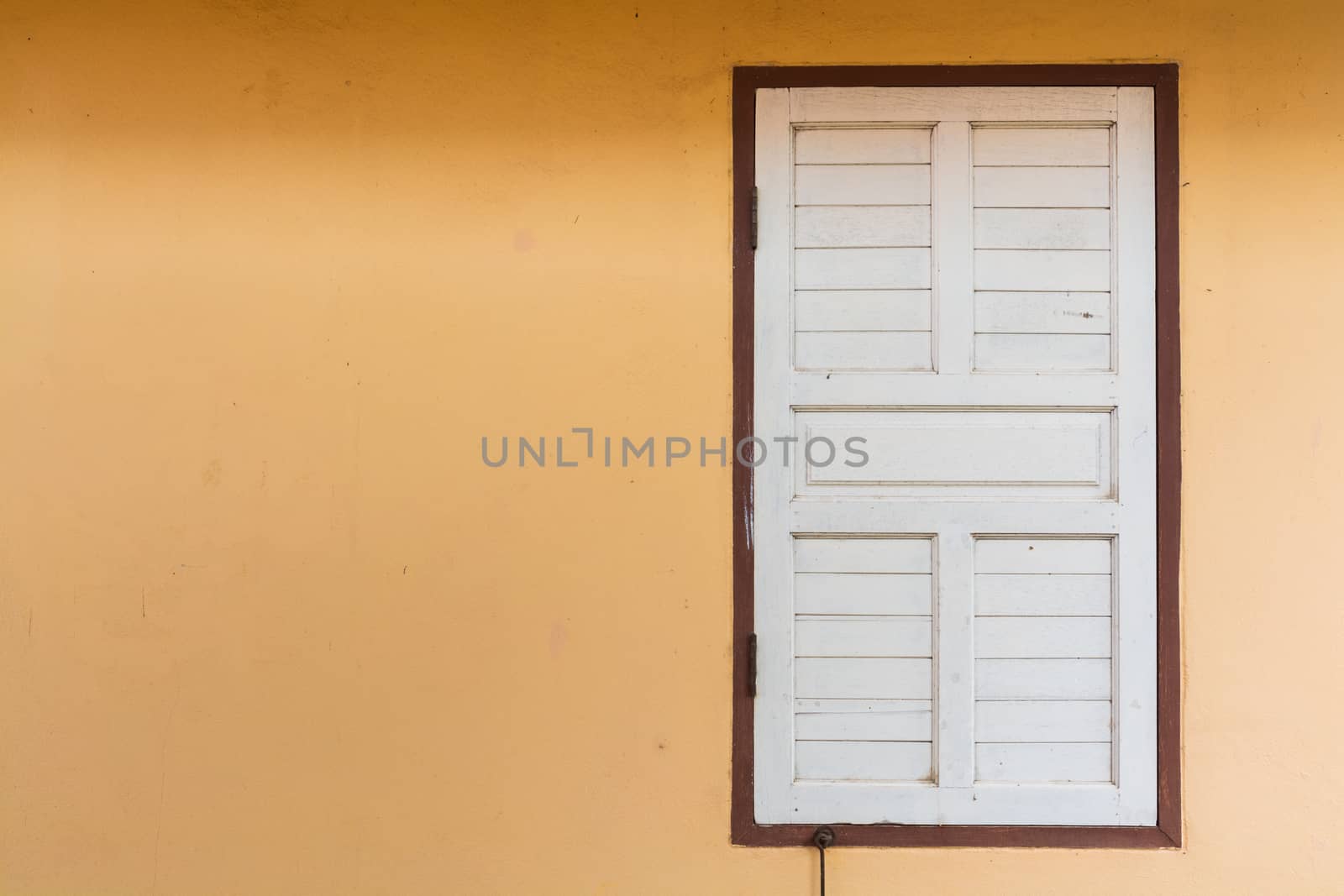 White Old Wood Window on Blank Orange Painted Cement Wall   by thampapon
