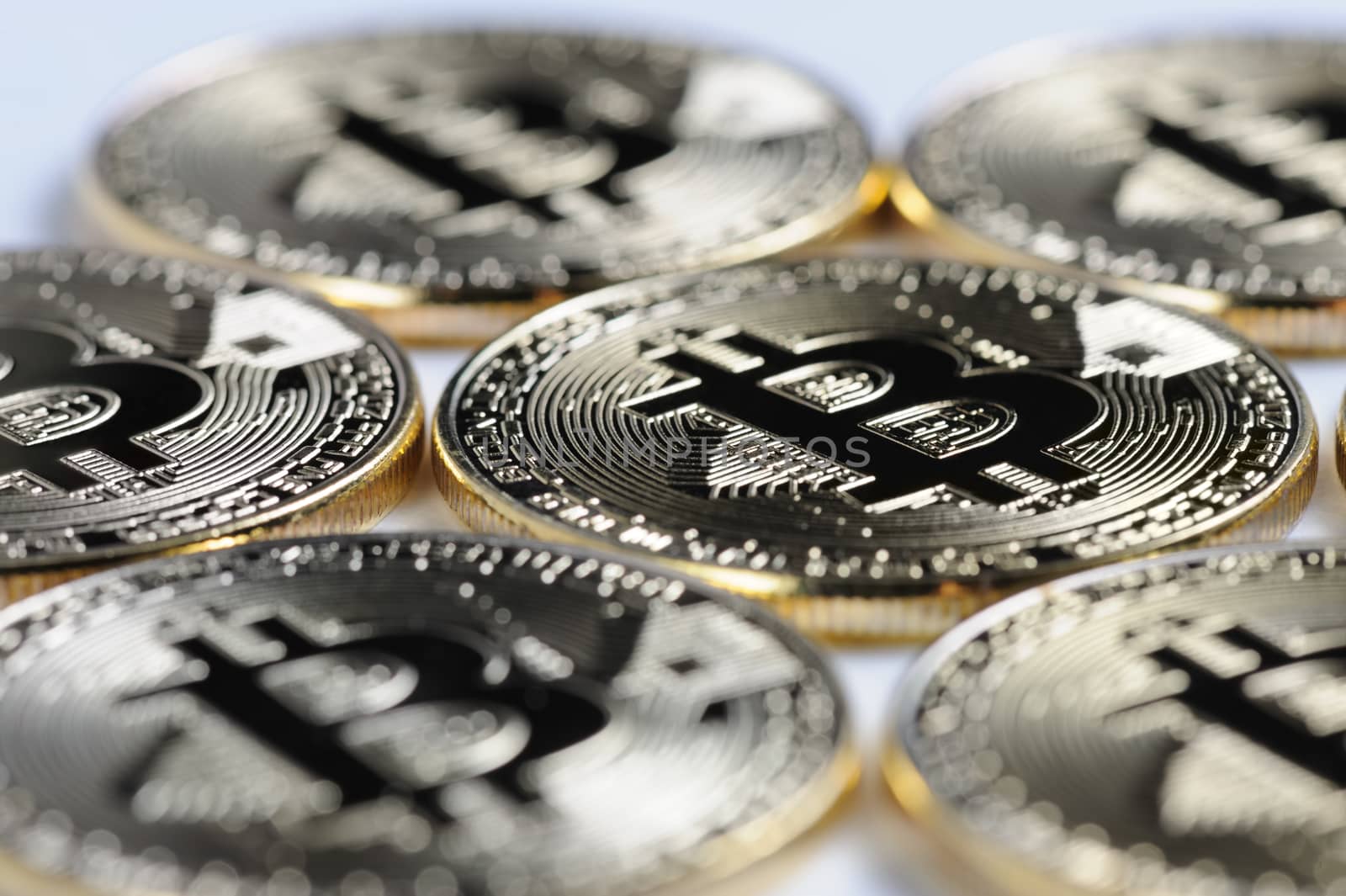 Macro view of shiny Bitcoin souvenire coins on light background, selective focus