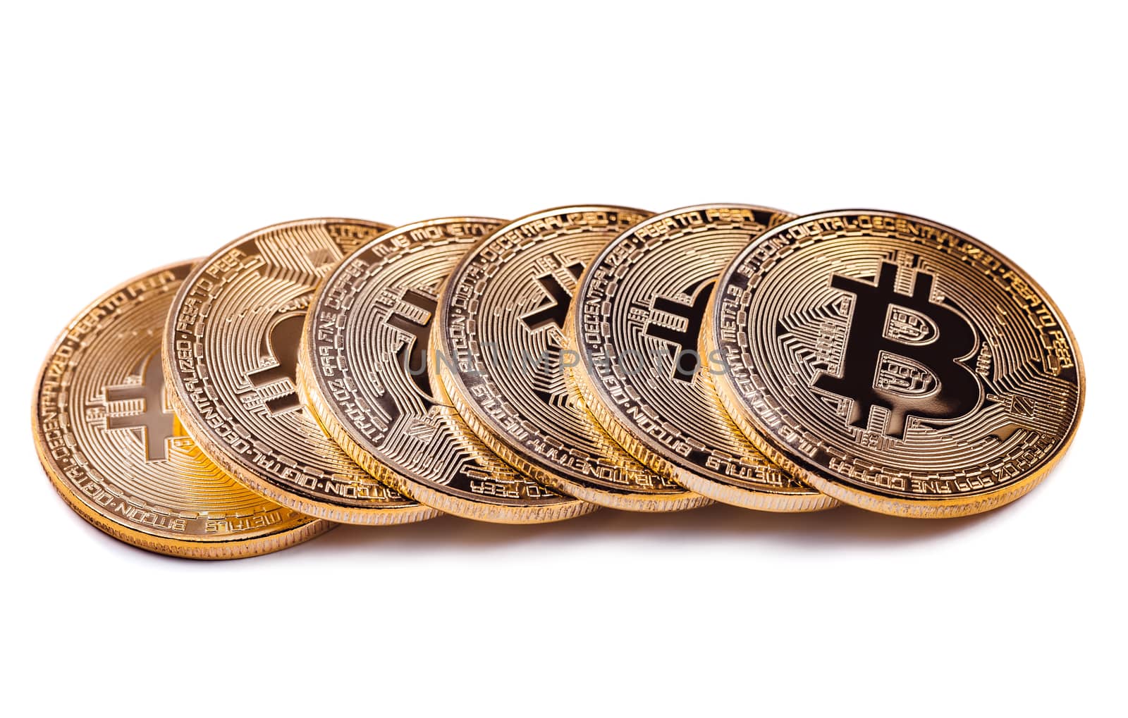 Macro view of shiny Bitcoin souvenire coins row, isolated on white