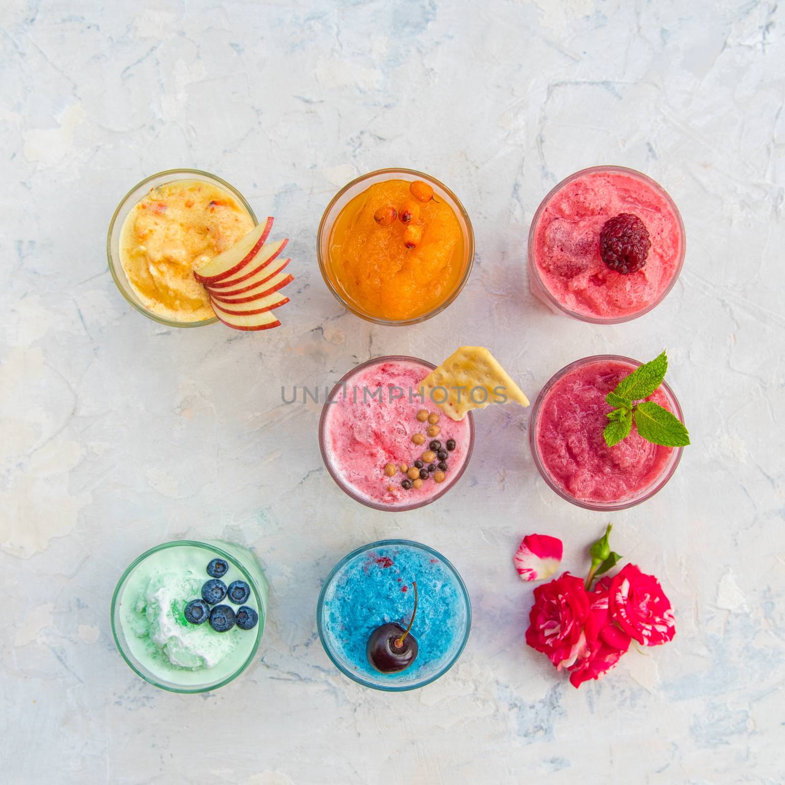 Different smoothie set on a white concrete background