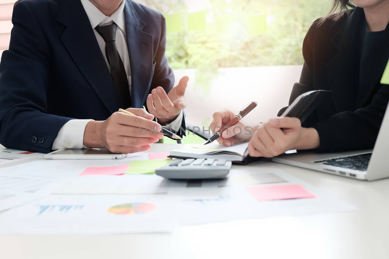 Financial planning Business man and Business woman talking to planner financial business, report finance in paper on office accounting desk.