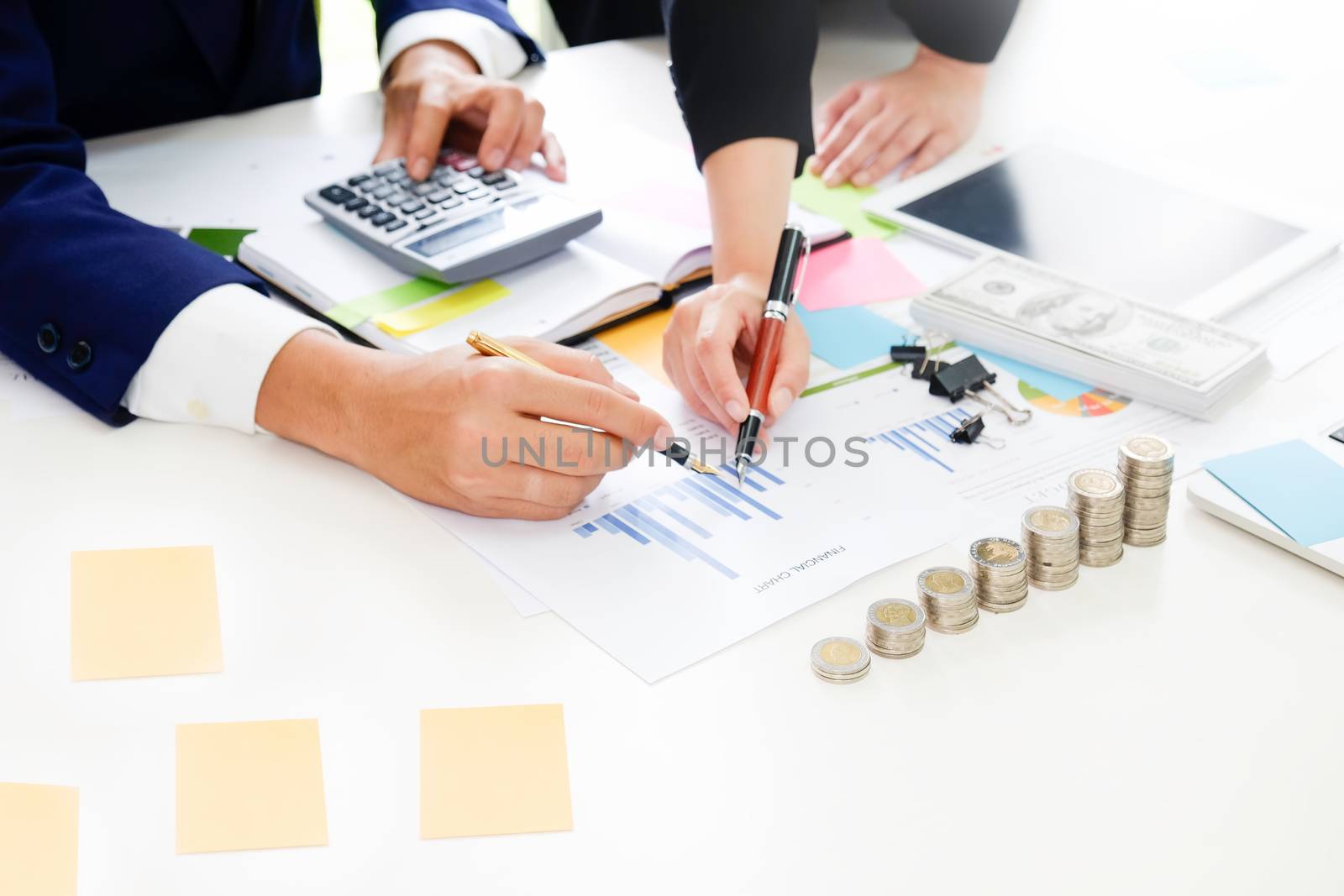Business adviser analyzing financial,Financial planning Business man and Business woman talking to planner financial business, report finance in paper on office accounting.