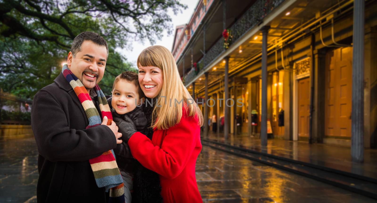 Happy Young Mixed Race Family Enjoying an Evening in New Orleans, Louisiana by Feverpitched
