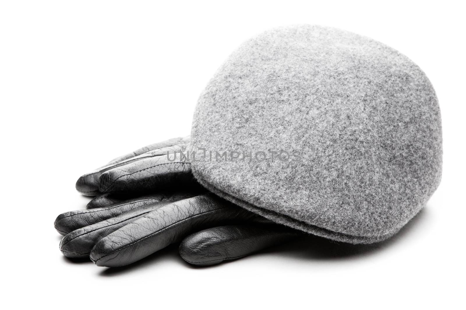 Tweed grey cap black leather gloves white background