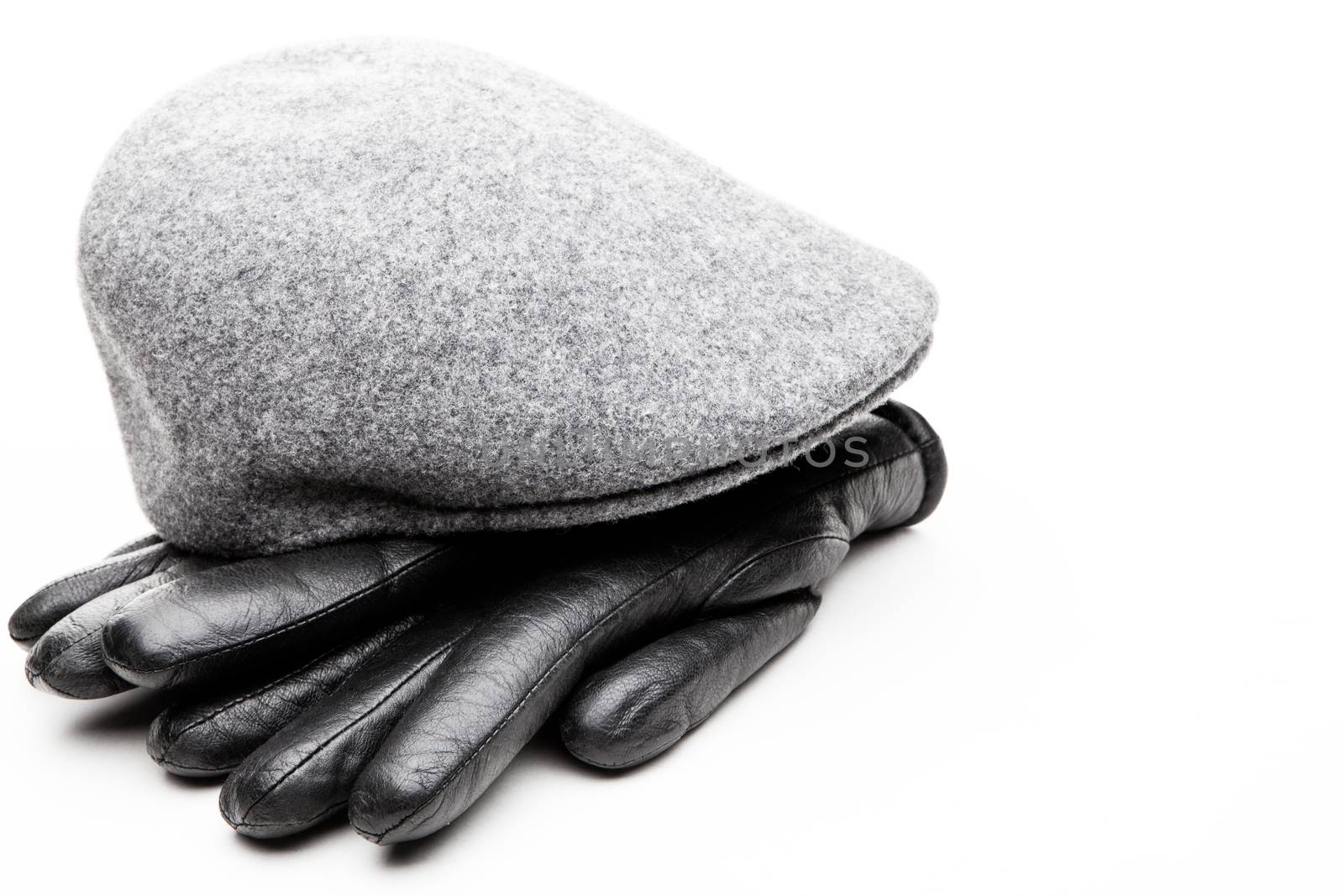 Tweed grey cap black leather gloves white background