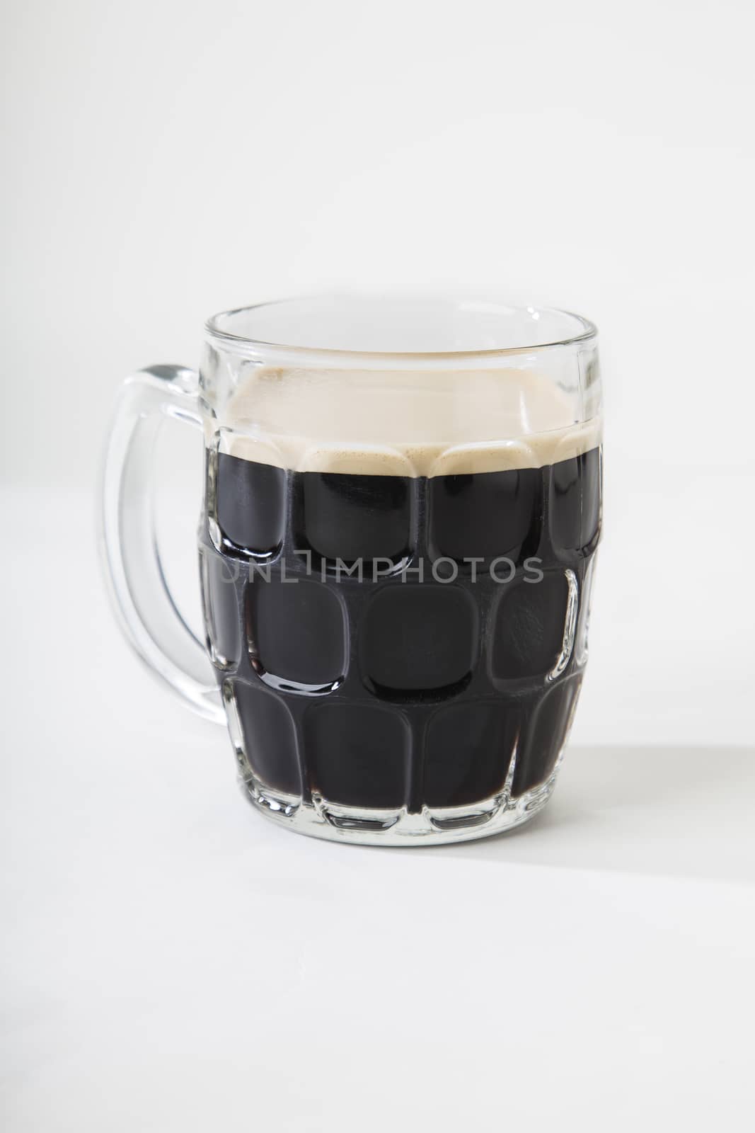 Black beer in a mug by mypstudio