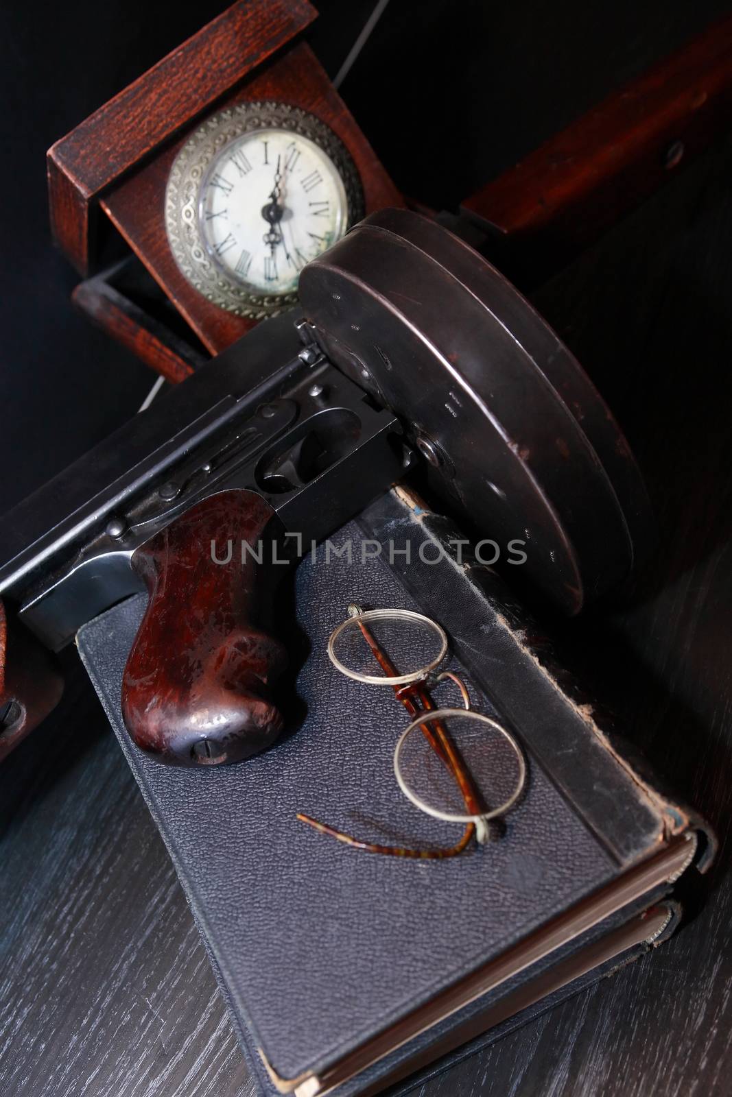 Old USA submachine gun closeup with books and spectacles