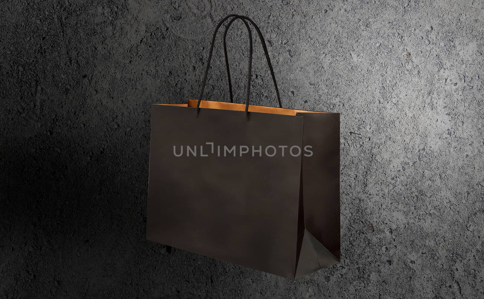 paper bag for shopping on a dark background by boys1983@mail.ru