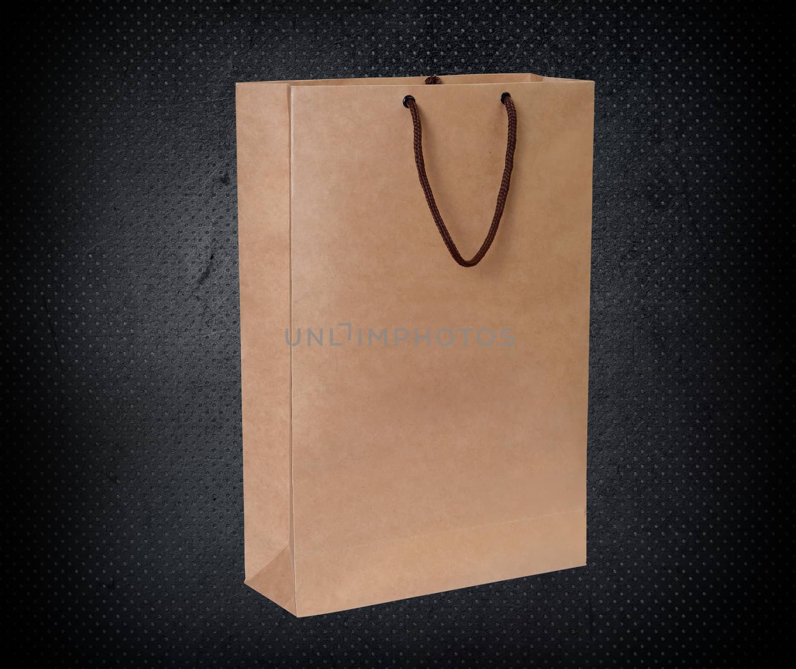 paper bag for shopping on a dark background by boys1983@mail.ru