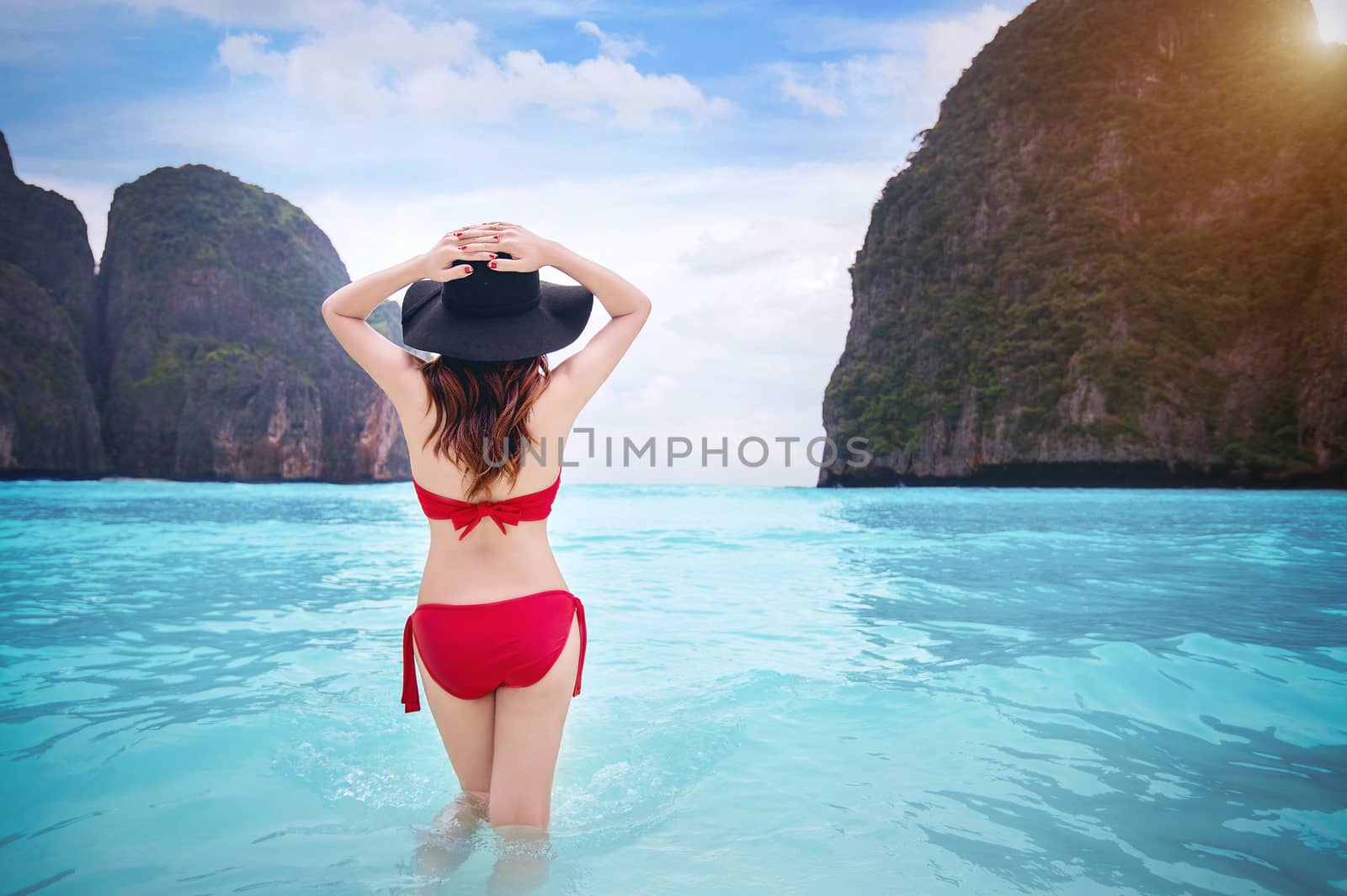 Woman in red bikini at tropical beach. Vintage tone