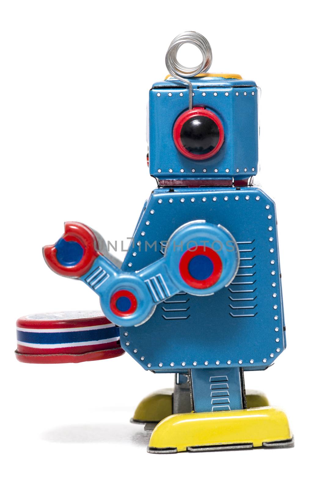 Vintage tin robot toy isolated on a white background.