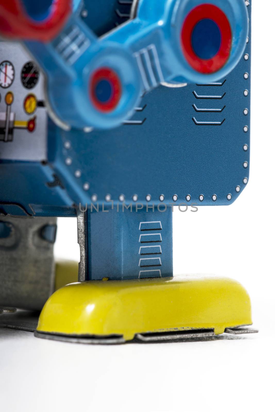 Vintage tin robot toy isolated on a white background.