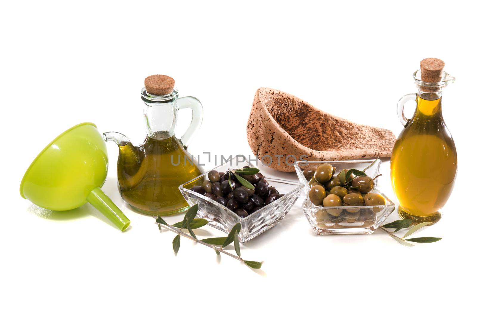 Green and black olives with olive oil bottles isolated on a white background.