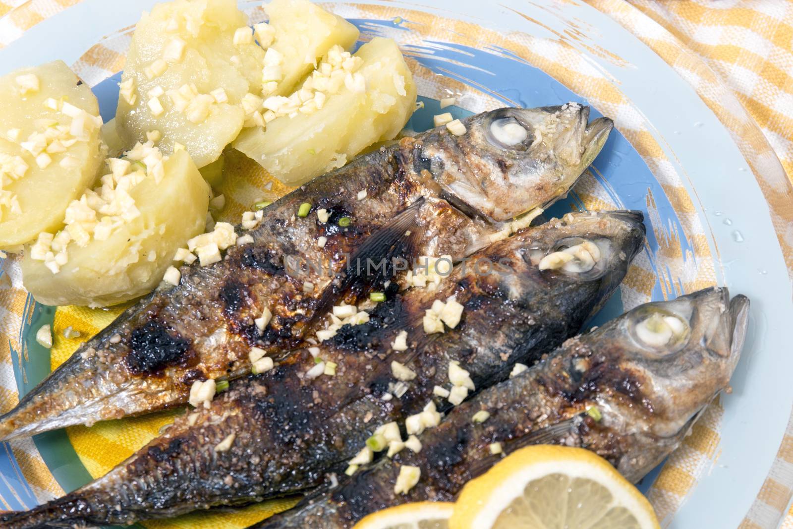 Grilled atlantic horse mackerel meal with potatoes.