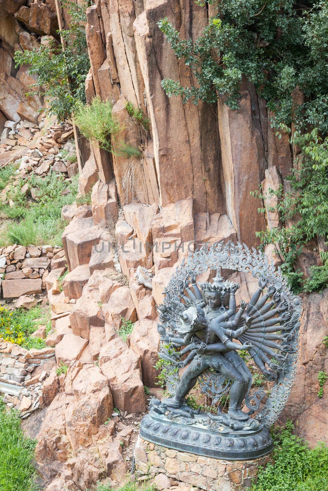 Tantric Deities statue in Ritual Embrace located in a mountain g by Perseomedusa