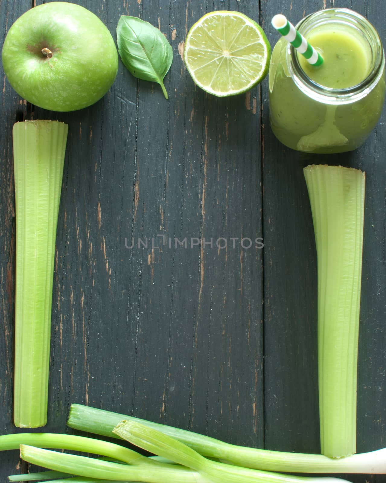 Blended smoothie with fresh ingredients on a wooden table with space for text 