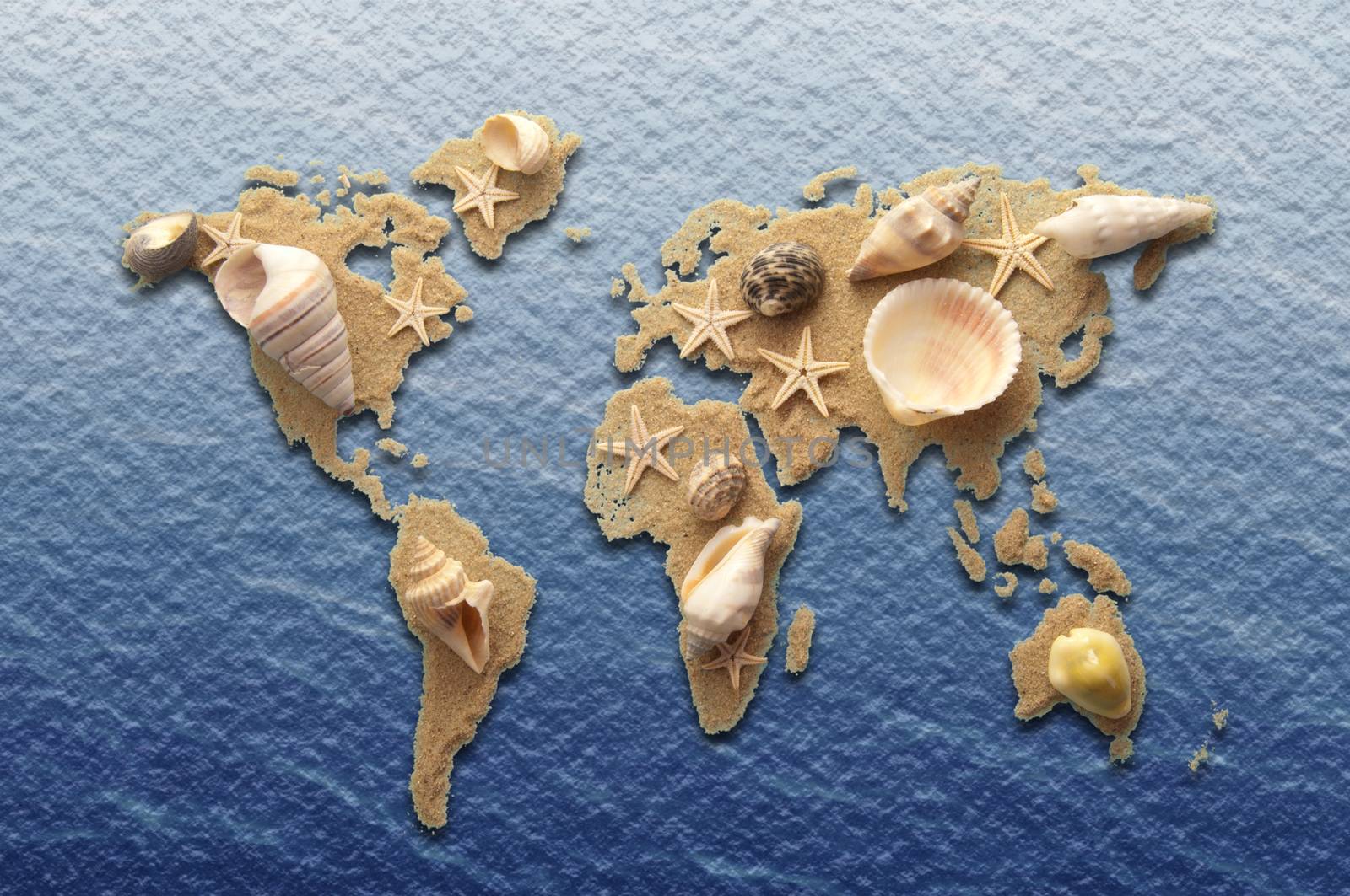 World atlas made from sand and sea shells on a sea background