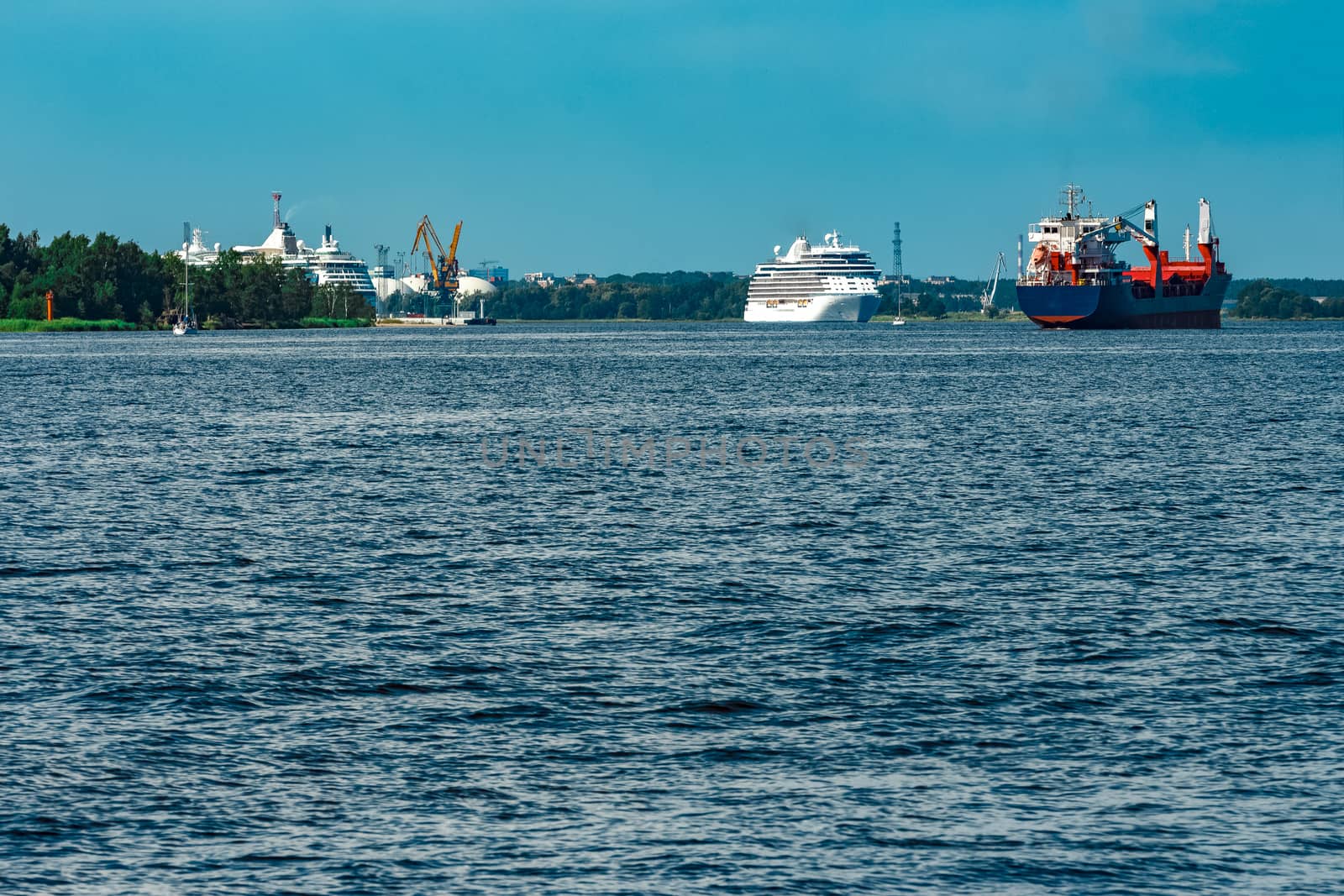 Merchandise import. Large blue cargo ship moving to Riga port