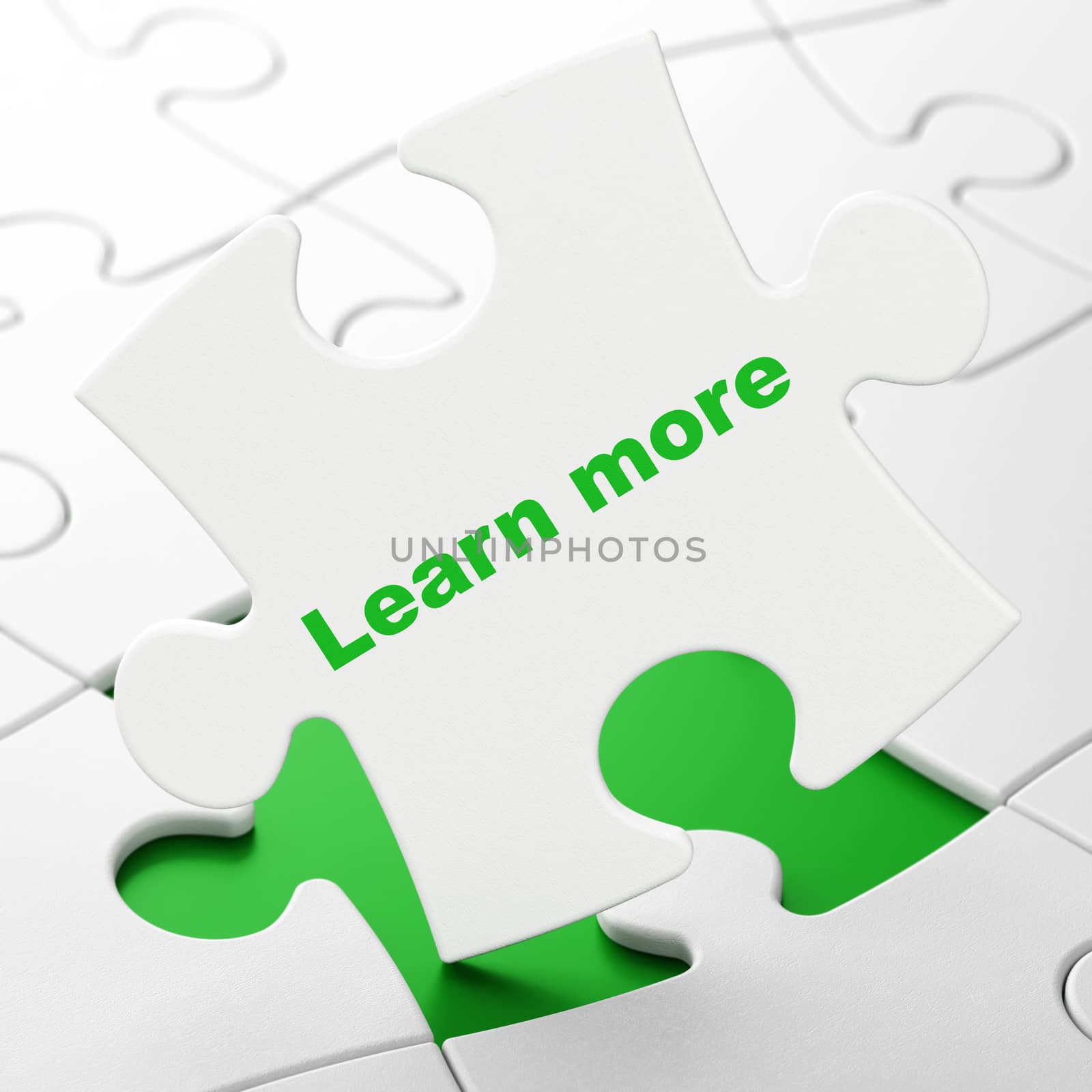 Learning concept: Learn More on White puzzle pieces background, 3D rendering