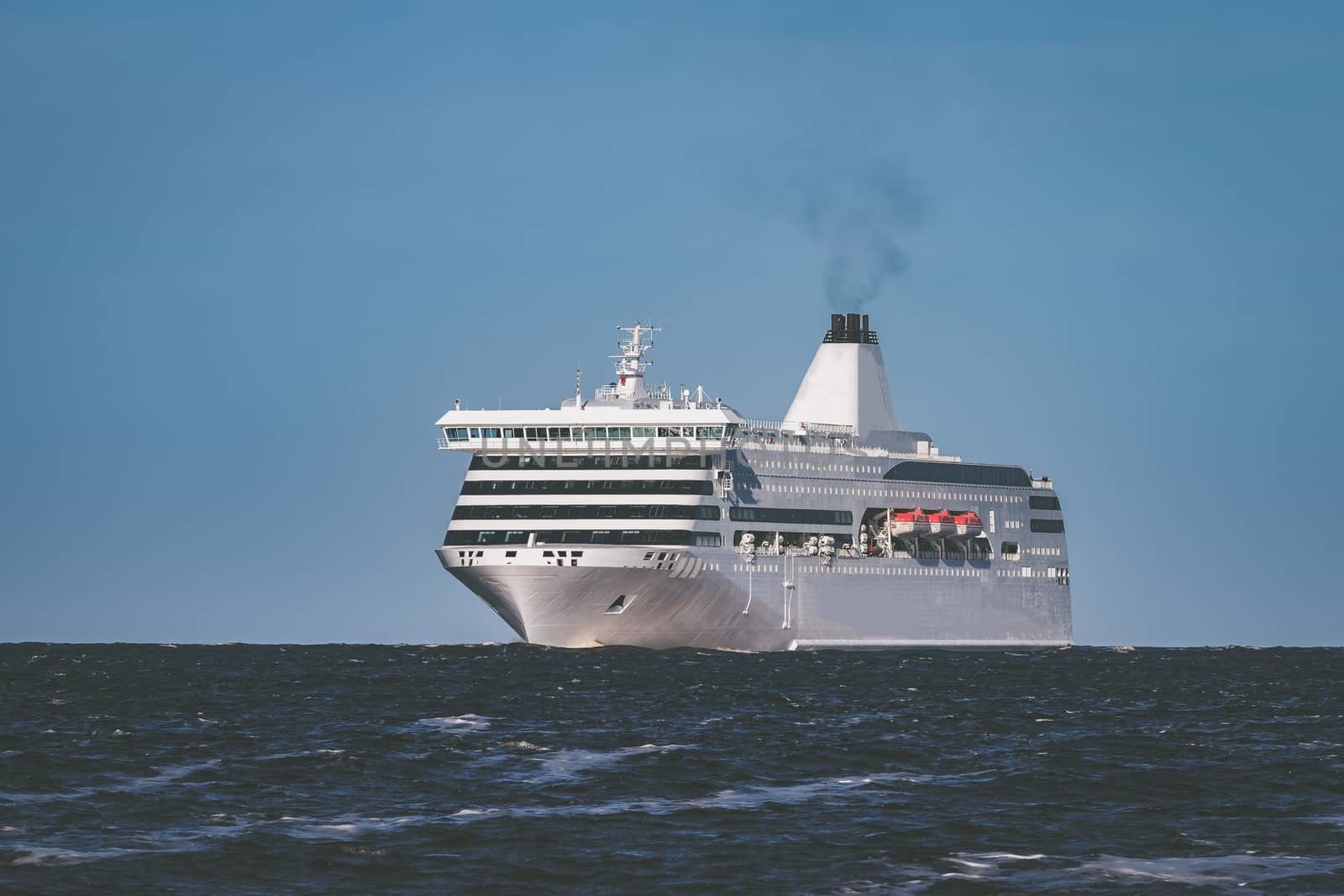 White cruise liner sailing on a clear day