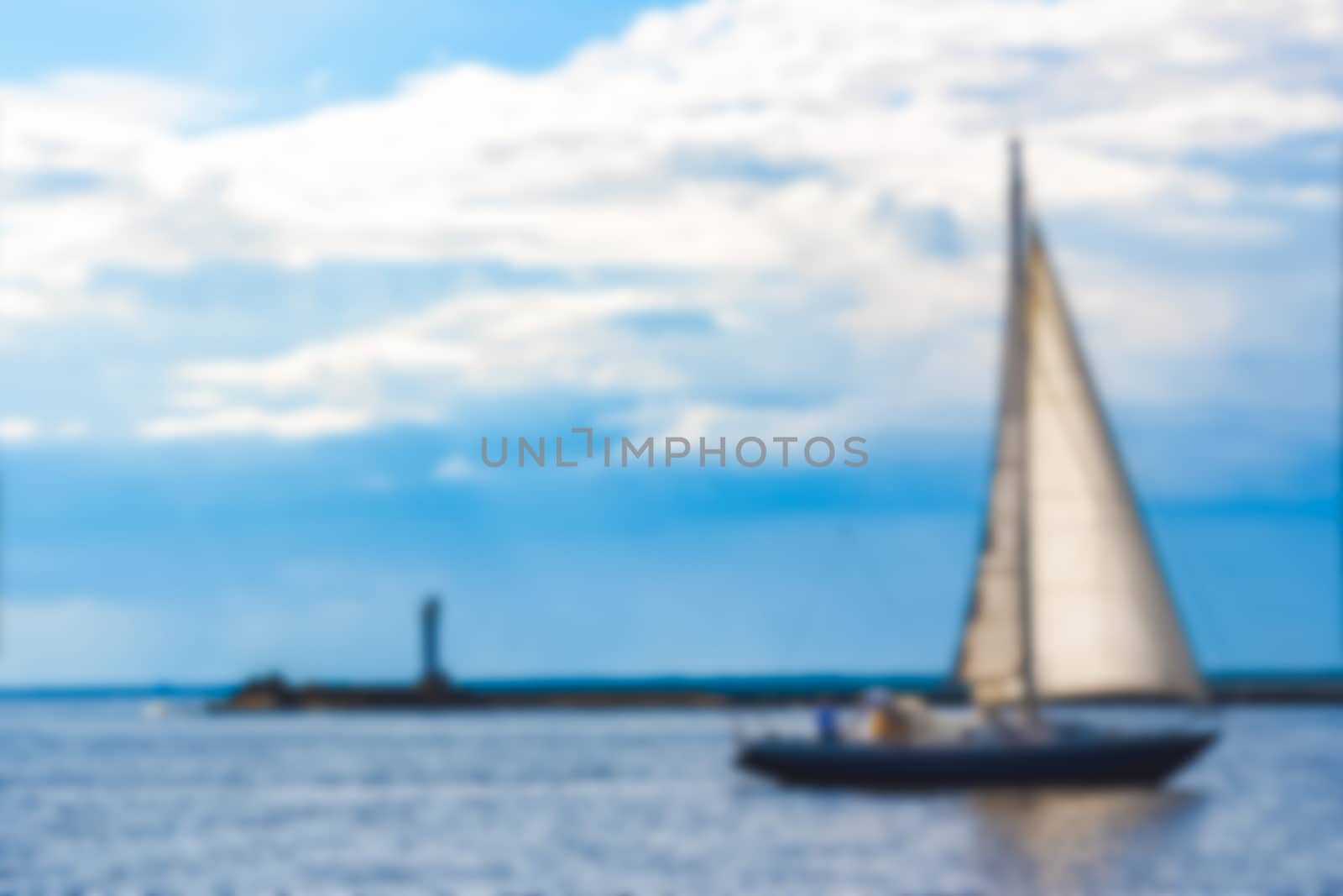 Blue sailboat - soft lens bokeh image. Defocused background