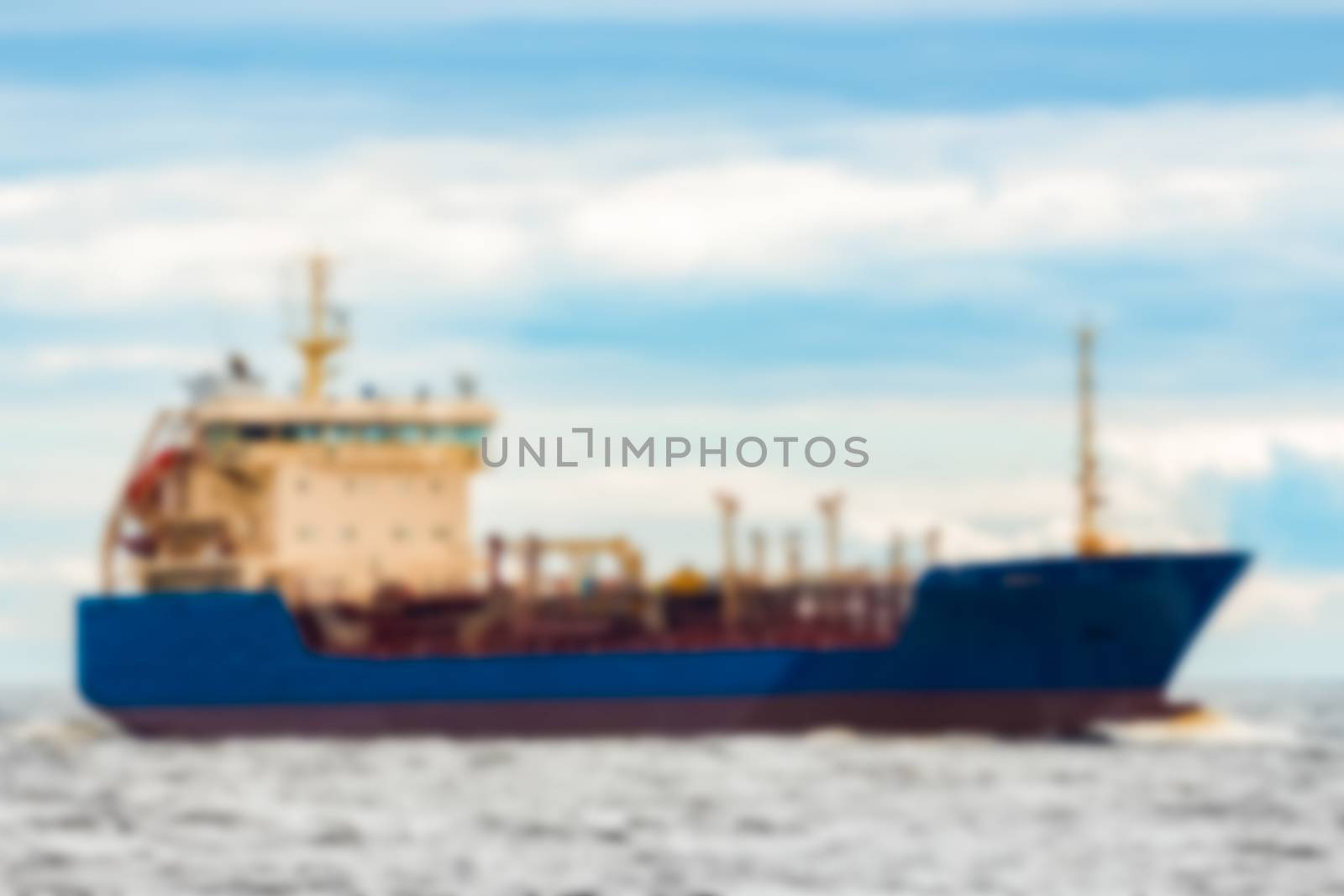 Blue cargo ship - soft lens bokeh image. Defocused background