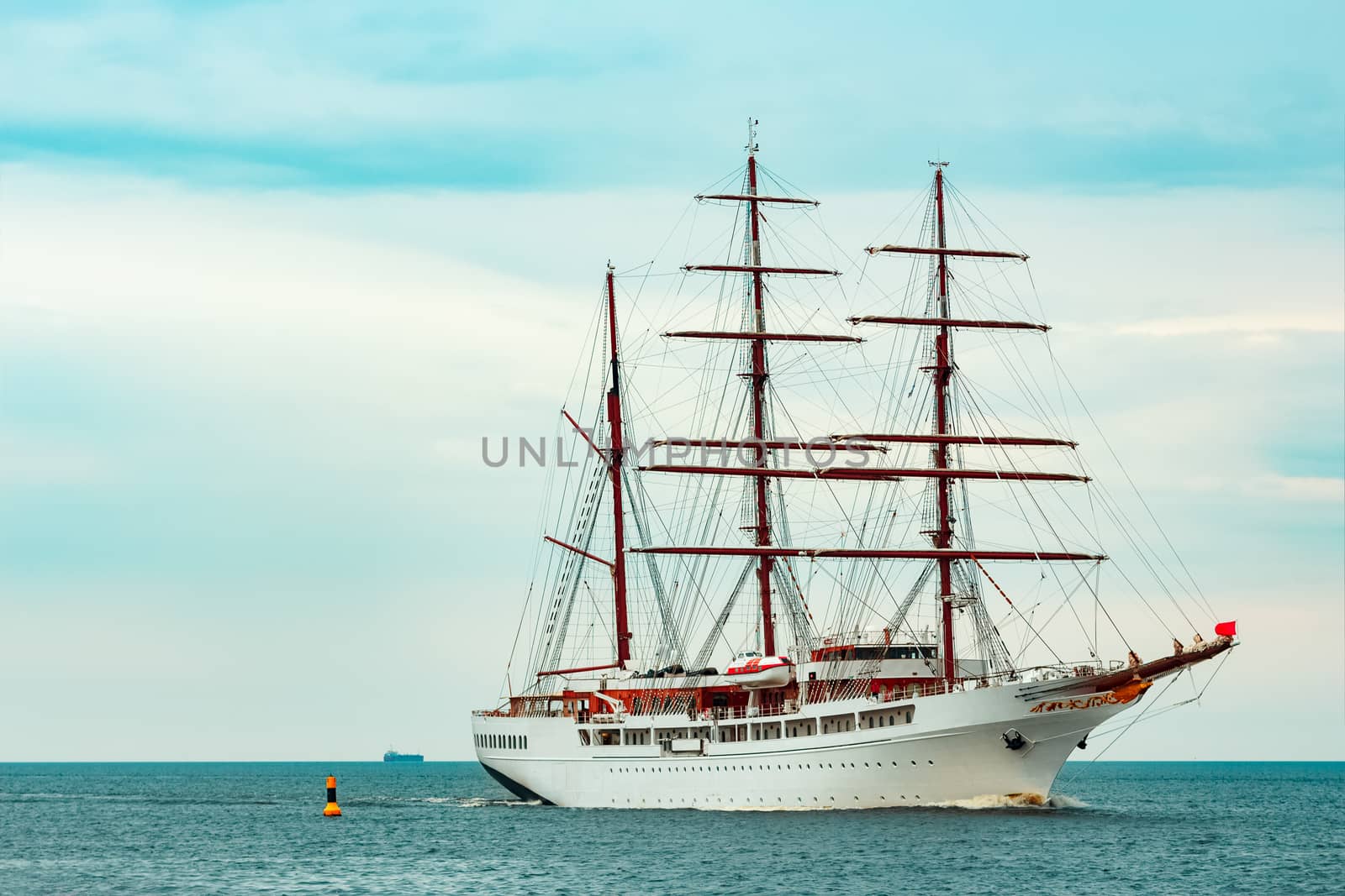 Big white sailing ship with three mast moving to the Riga port