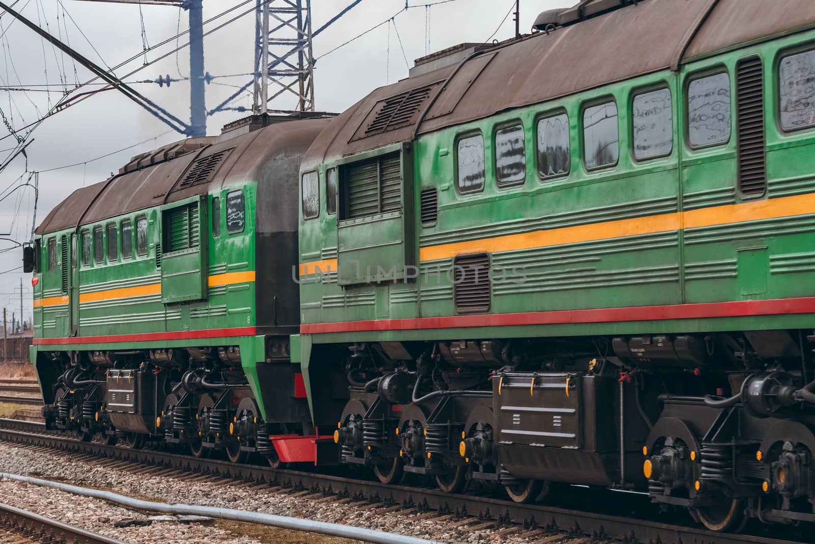 Green diesel cargo locomotive. Freight train in action