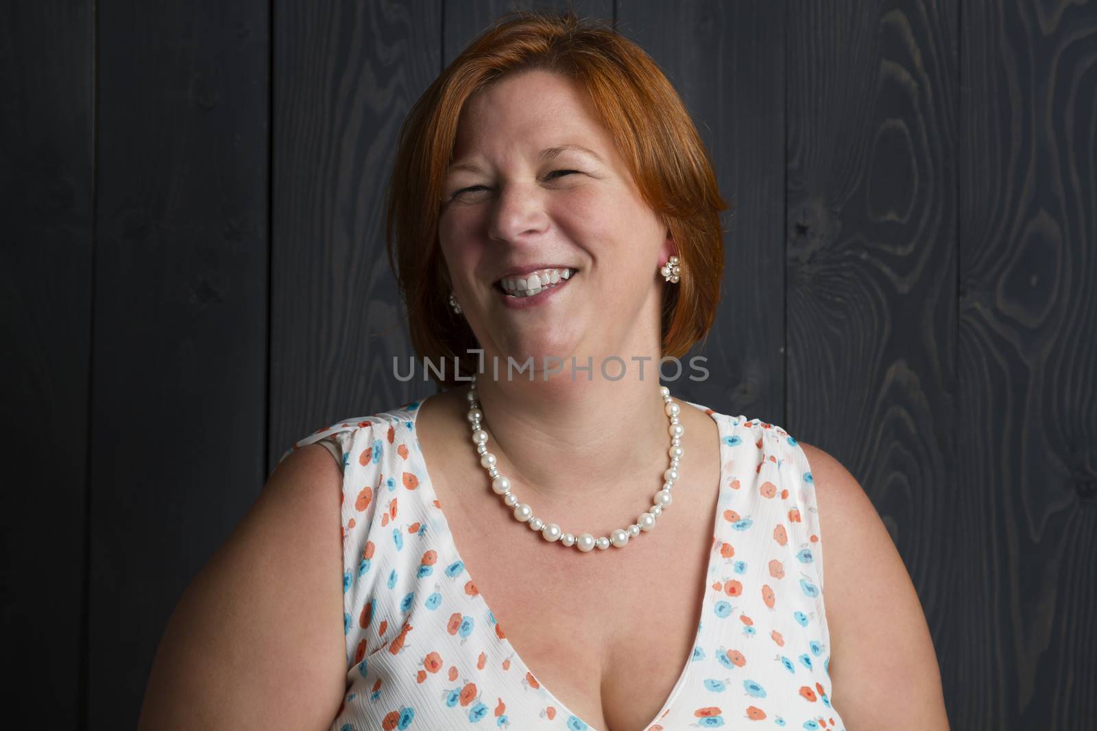 portrait of a red head woman laughing