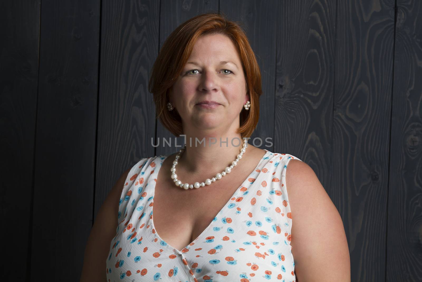 woman in her forties against a wood stained background